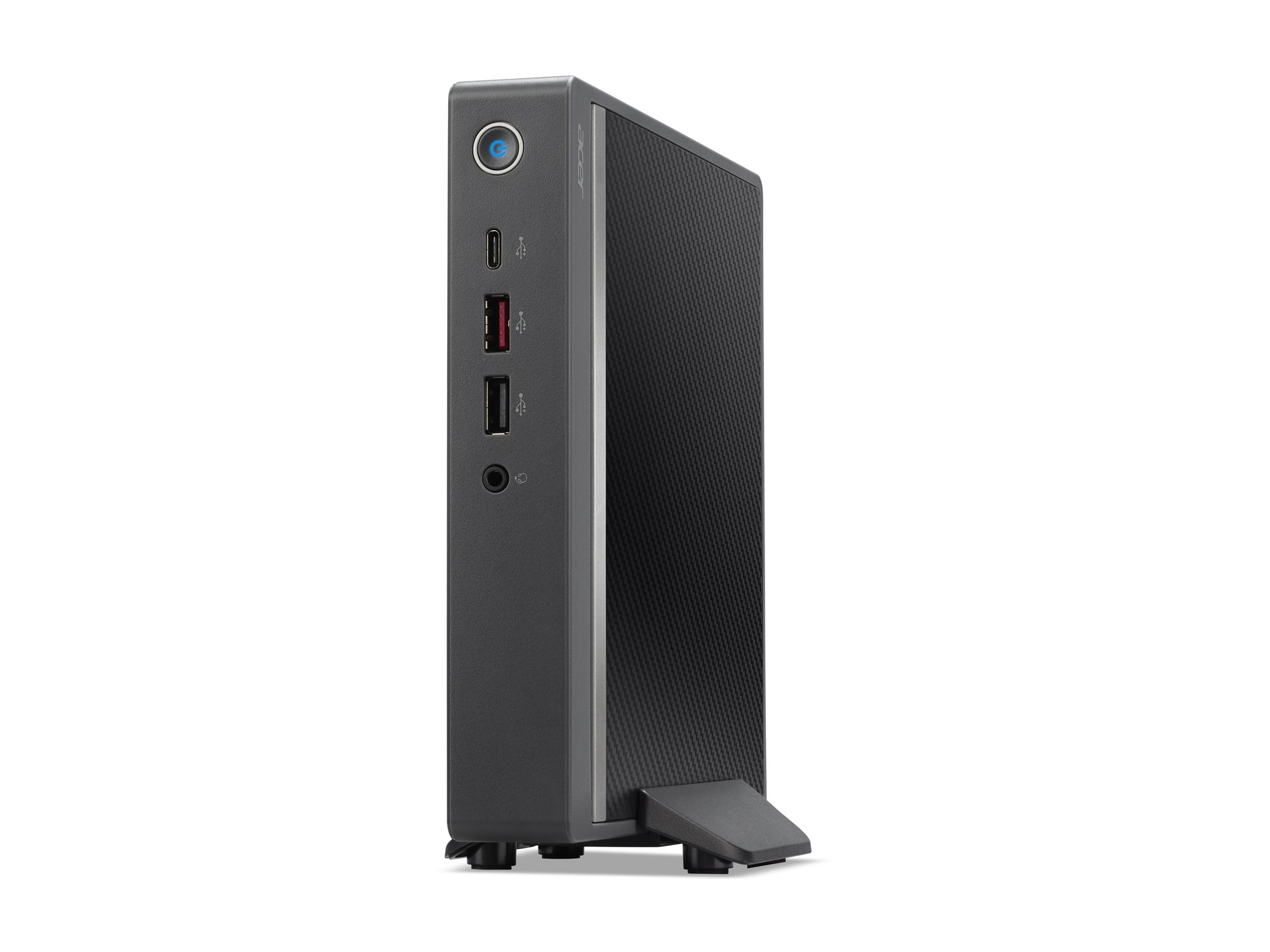 Un piccolo computer nero con porte, in piedi su una superficie bianca.
