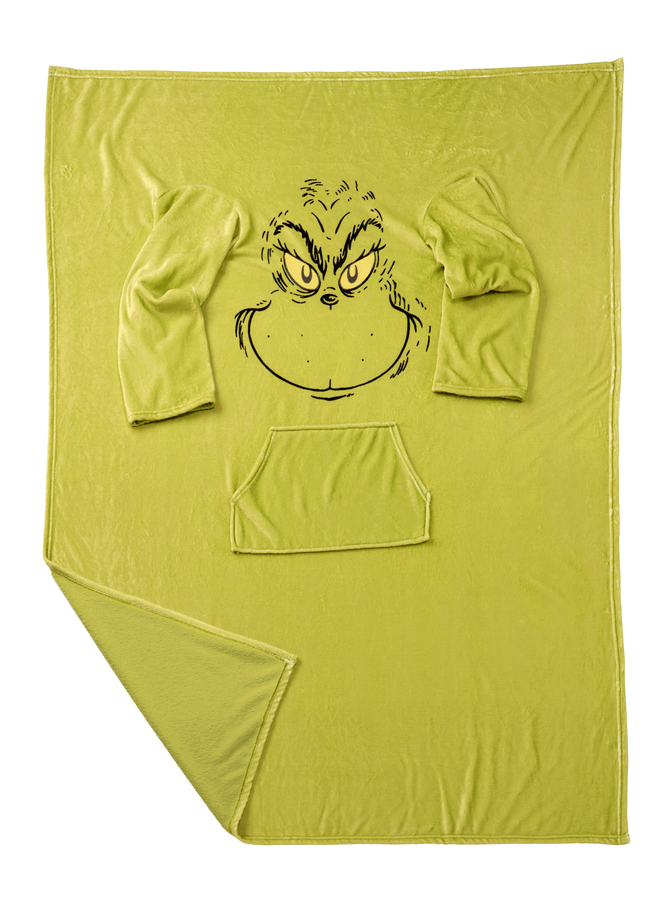 Eine grüne Decke im Grinch-Stil mit Armen und einer Tasche, mit dem Gesicht des Grinch.