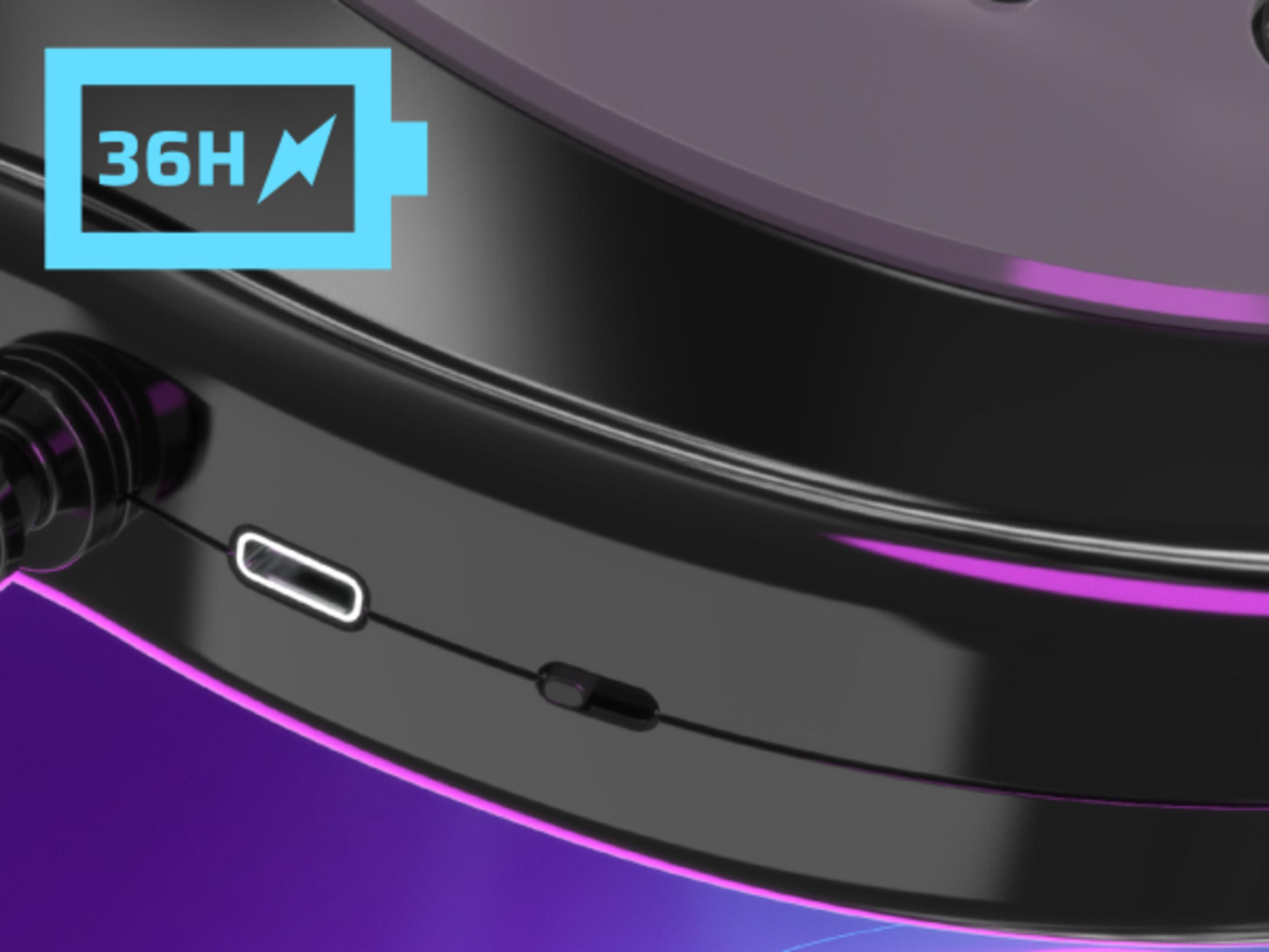 Zbliżenie na smartwatch pokazujące port ładowania i ikonę baterii z 36H, wskazującą żywotność baterii.