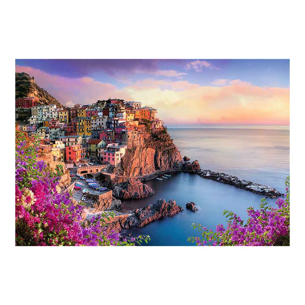 Puzzle of Manarola, Italy. Colorful buildings on a cliff, sea, and purple flowers in foreground.