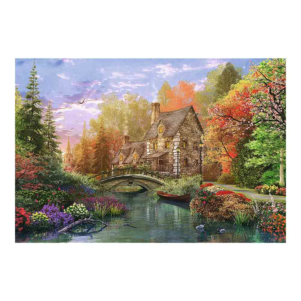 Scena z puzzli, kamienny domek nad rzeką, most i łódź, otoczony drzewami w jesiennych barwach.