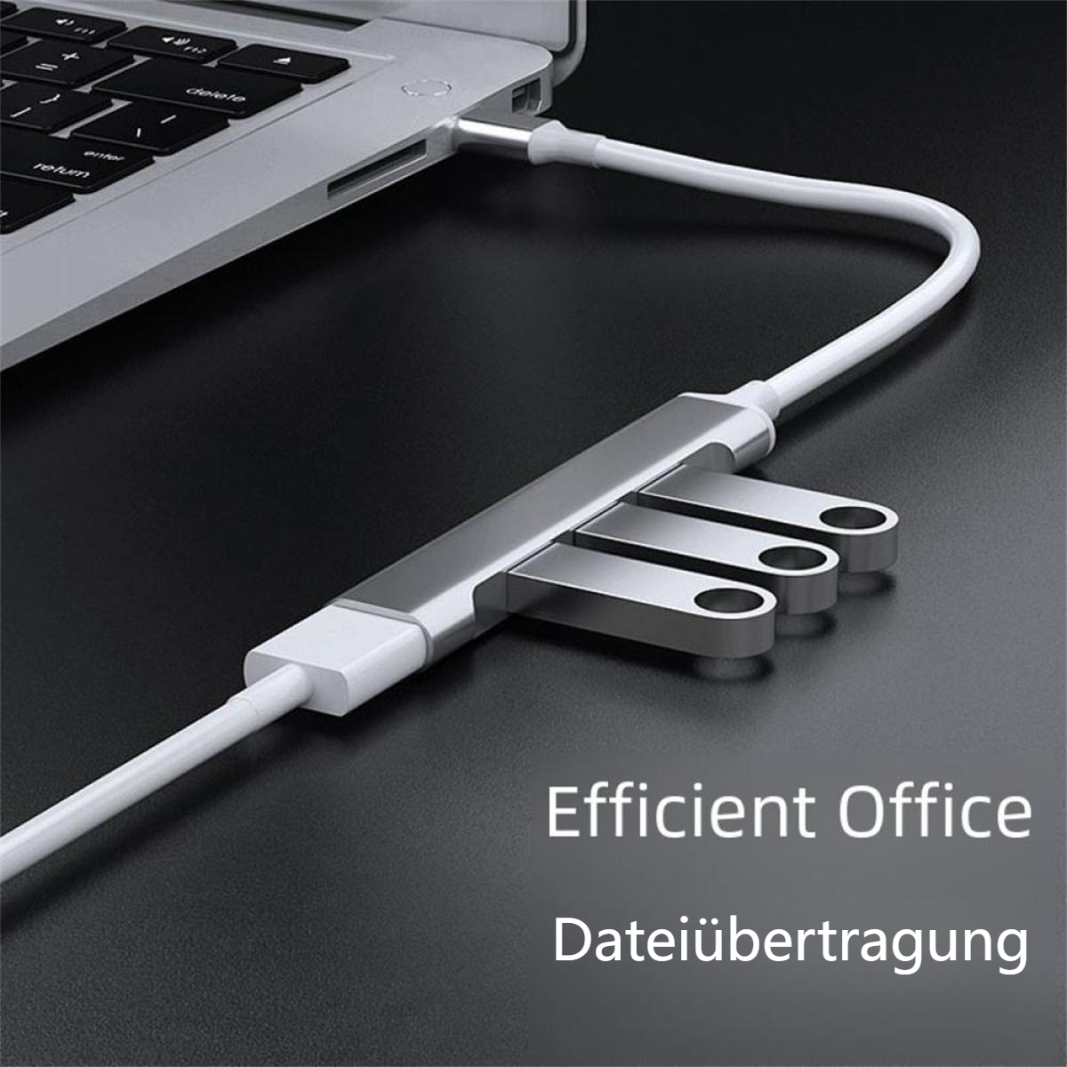 Ein silberner Hub mit USB-Laufwerken, die über ein weißes Kabel mit einem Laptop verbunden sind.