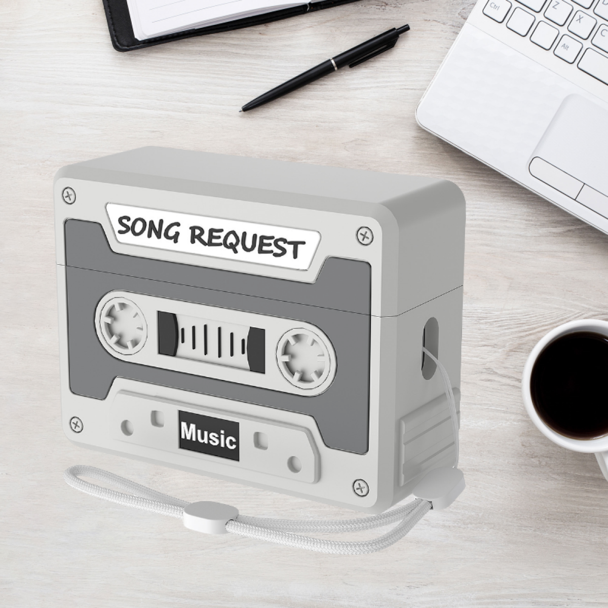 Una caja gris en forma de cassette con las palabras "SONG REQUEST" y "Music".