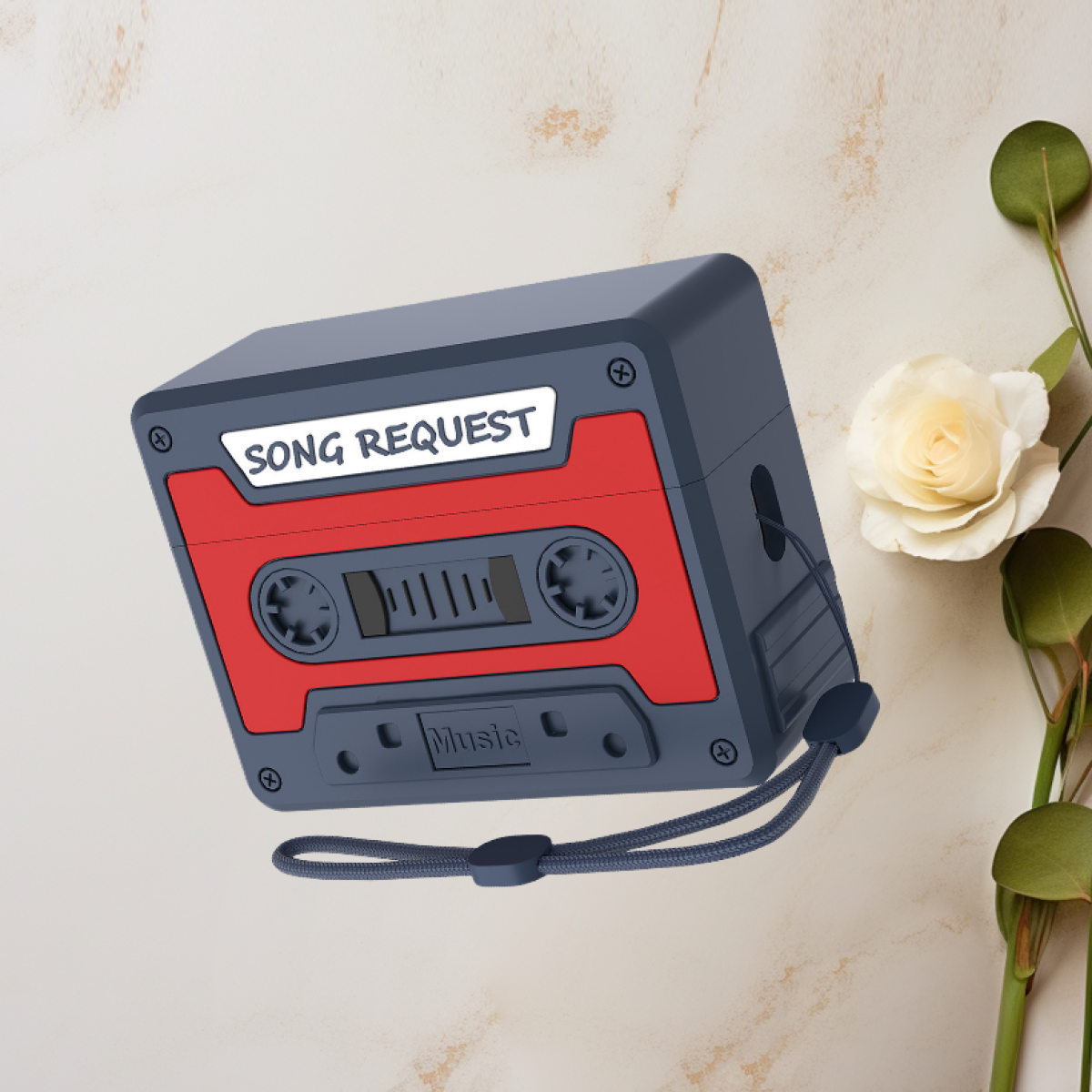Un estuche de auriculares con forma de cassette retro, con cinta roja y cuerpo azul marino.