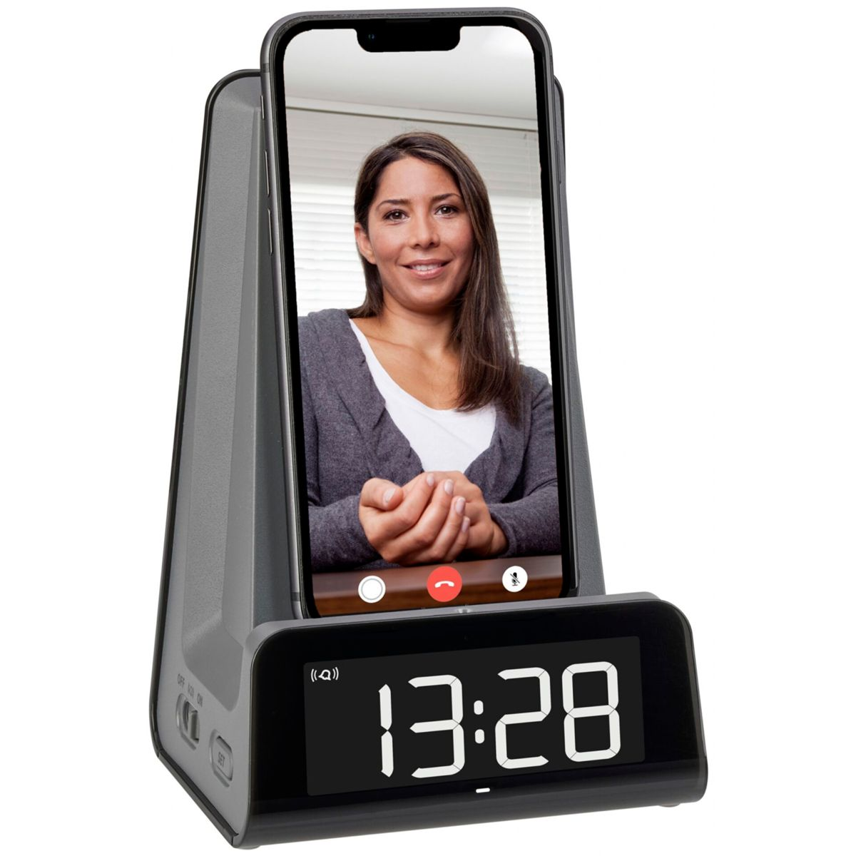 Ein Telefon in einer Dockingstation, das einen Videoanruf mit einer Frau und eine Uhr zeigt.