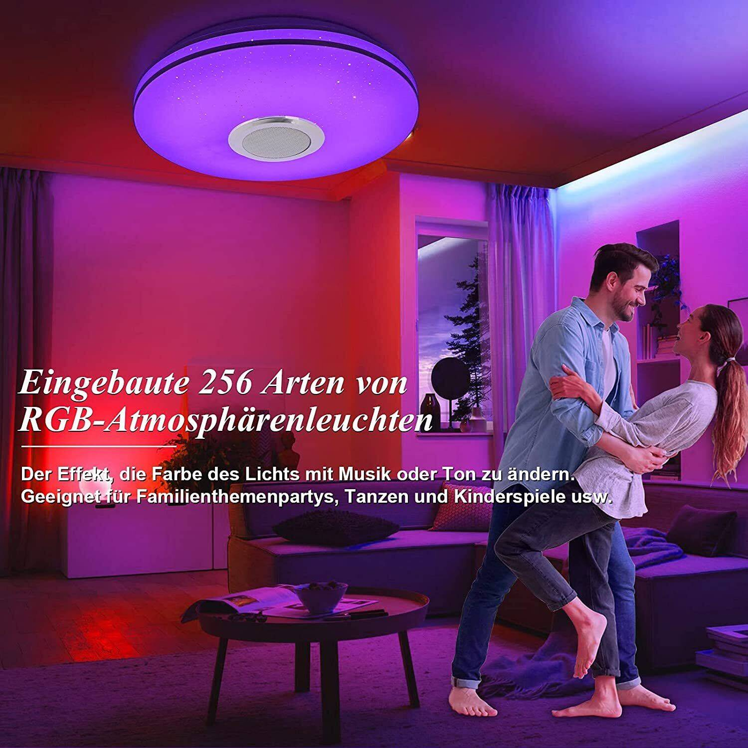 Paar tanzt unter einer violetten Deckenleuchte mit Lautsprecher.