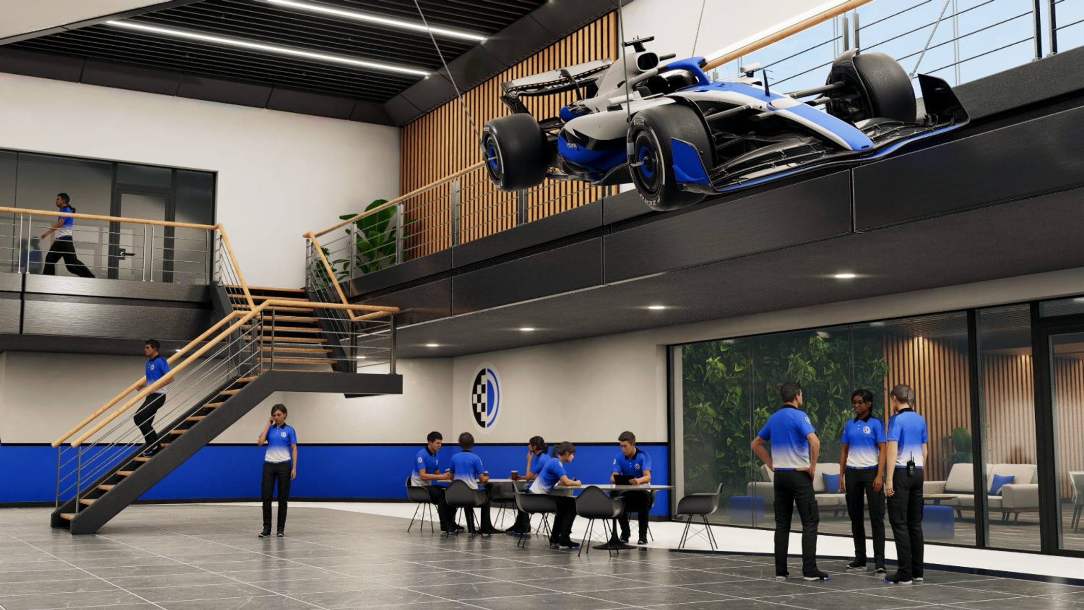 Nowoczesne wnętrze z bolidem Formuły 1 zawieszonym pod sufitem i ludźmi pracującymi poniżej.