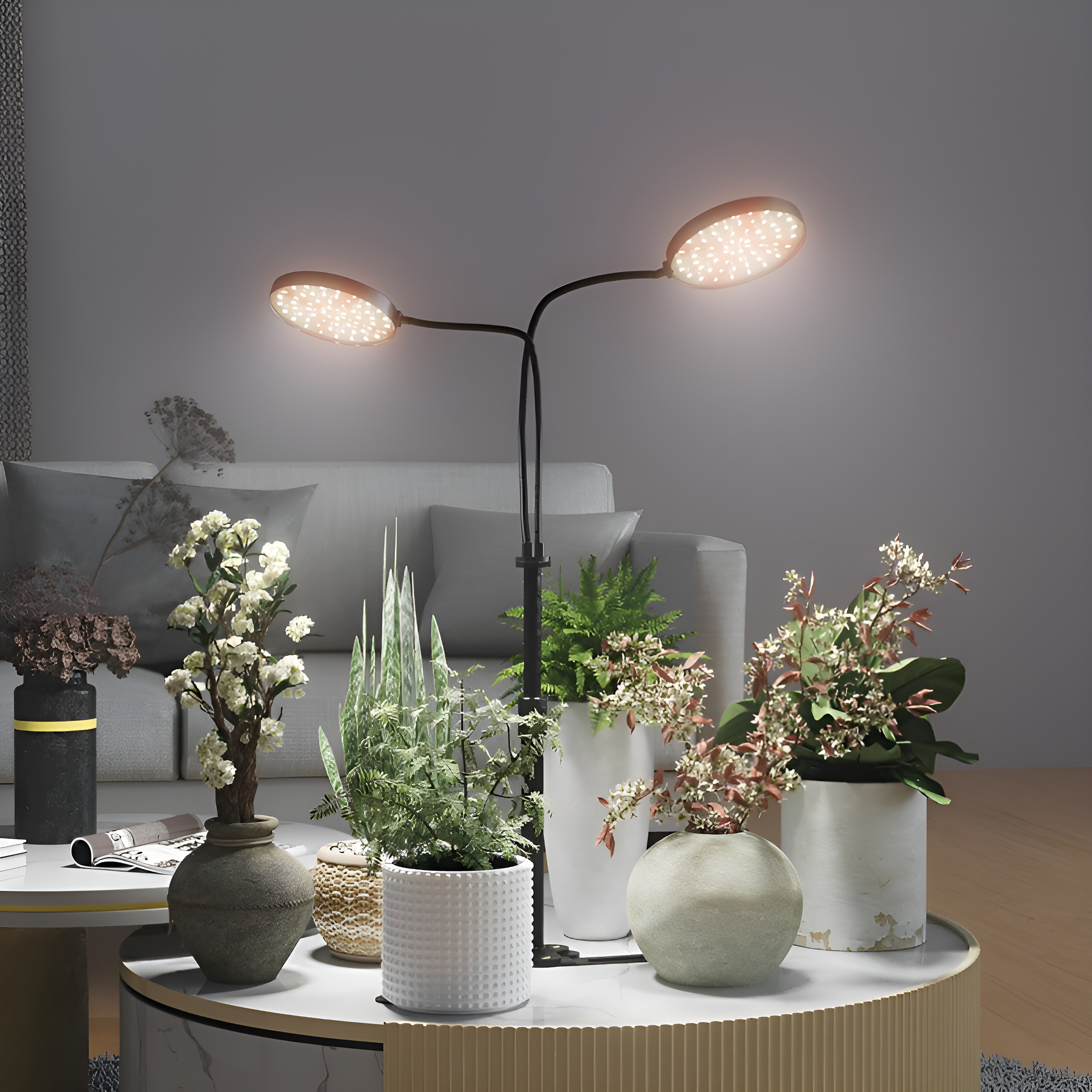Stehlampe mit zwei Lichtern und Pflanzen um einen Tisch. Sofa im Hintergrund.