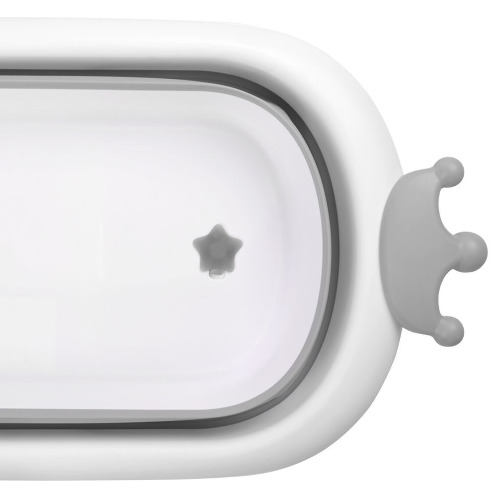 Weißer, oval geformter Behälter mit grauem Stern im Inneren und grauem kronenförmigen Griff.