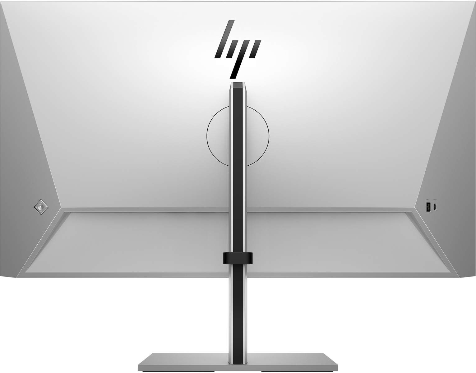 Tył srebrnego monitora HP z logo HP, czarną podstawą i portami z boku.