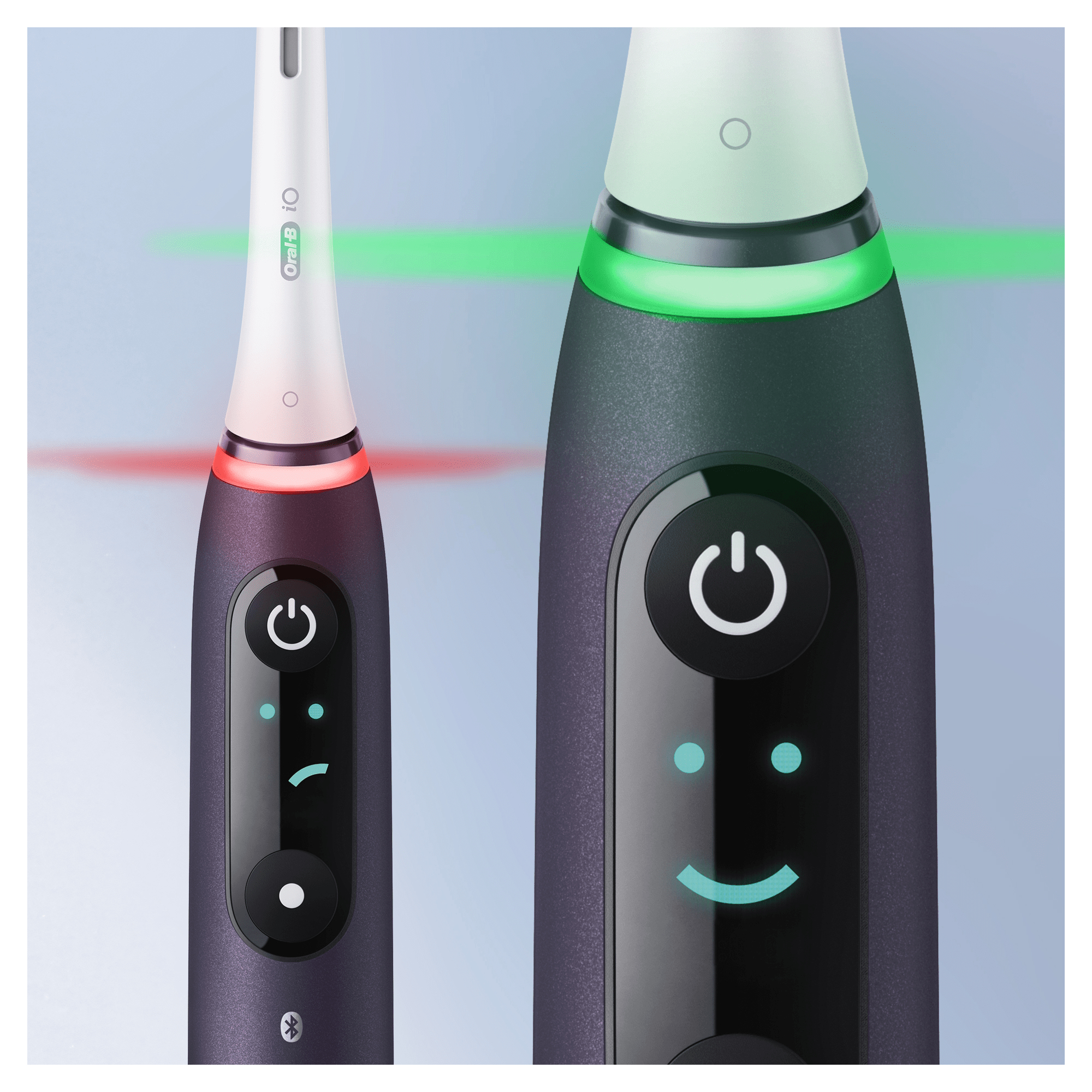 Elektryczne szczoteczki do zębów z wyświetlaczem. Jedna z czerwonymi i zielonymi światłami, druga z uśmiechem.