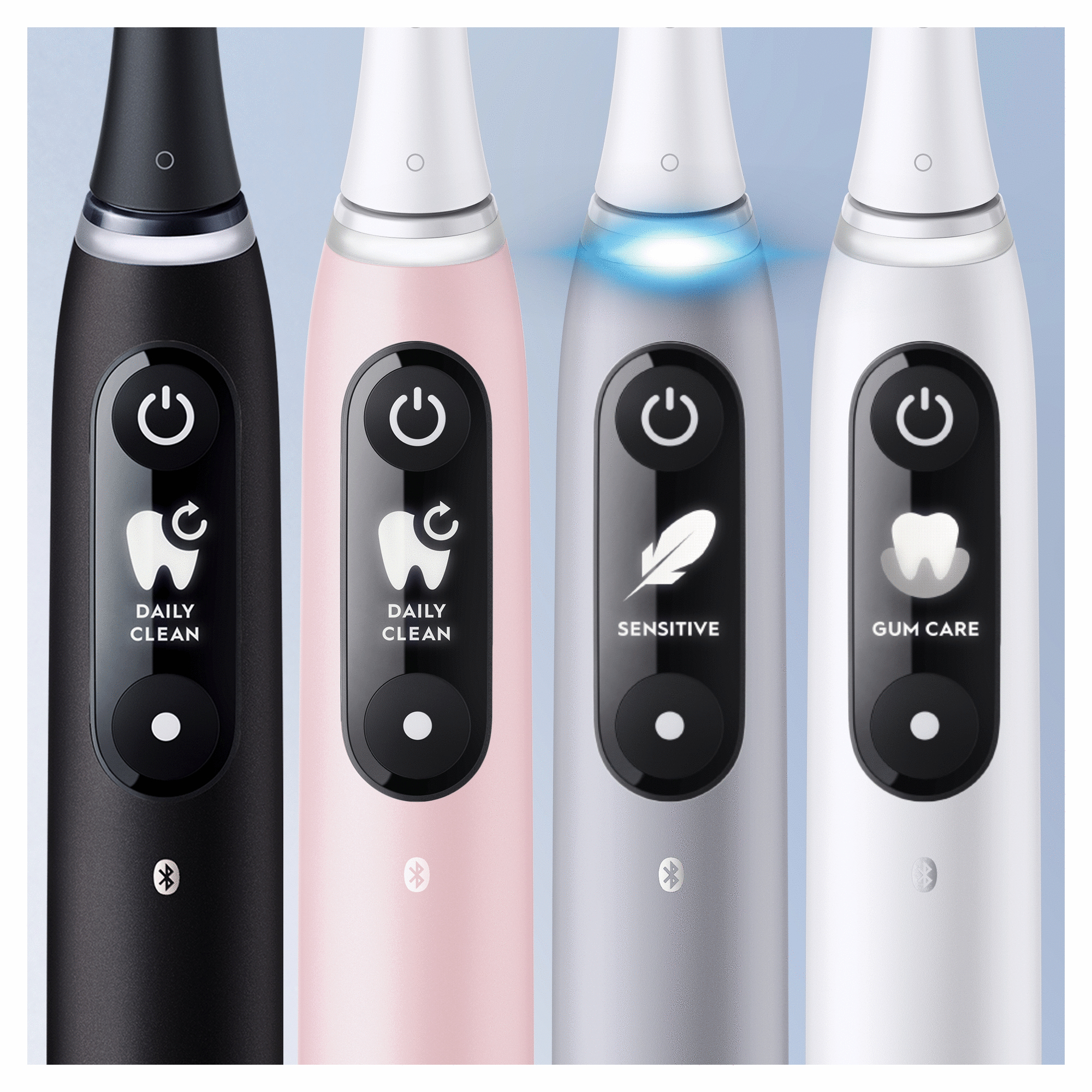 Cuatro cepillos de dientes eléctricos con diferentes modos de limpieza, negro, rosa, plateado y blanco.