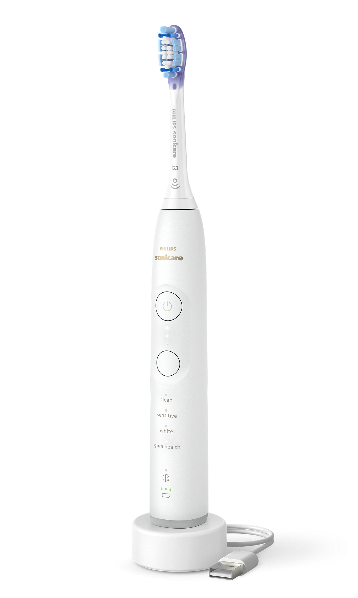 Cepillo de dientes eléctrico blanco sobre una base de carga blanca con cable USB.