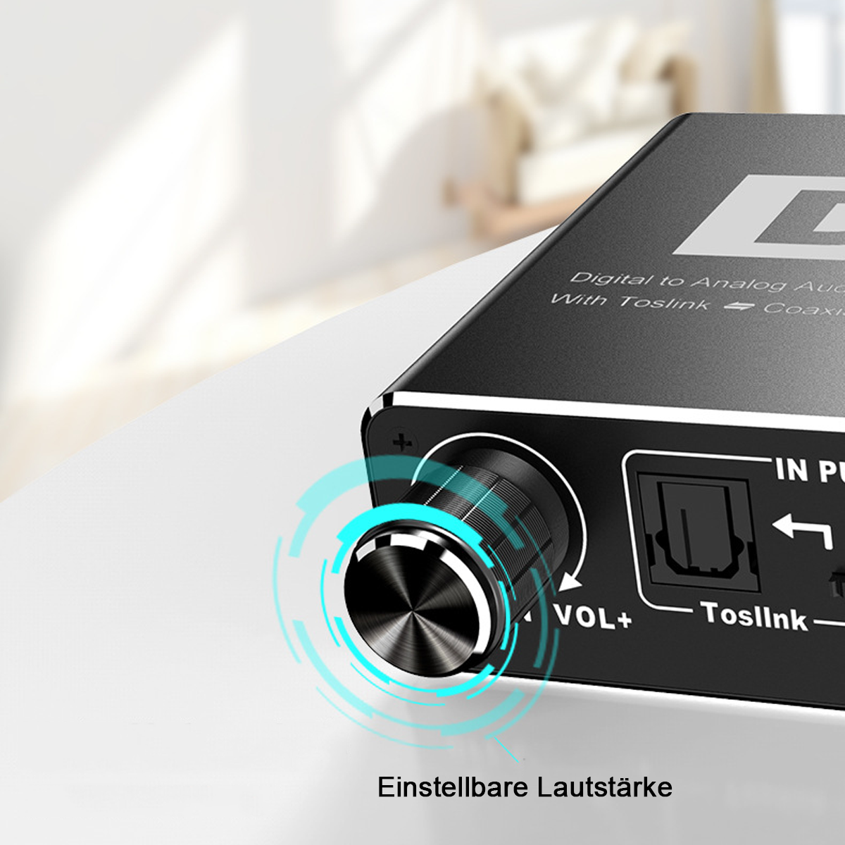 Schwarzes Audiogerät mit Lautstärkeregler. Text: 'Toslink' und 'Digital zu Analog Audio'.