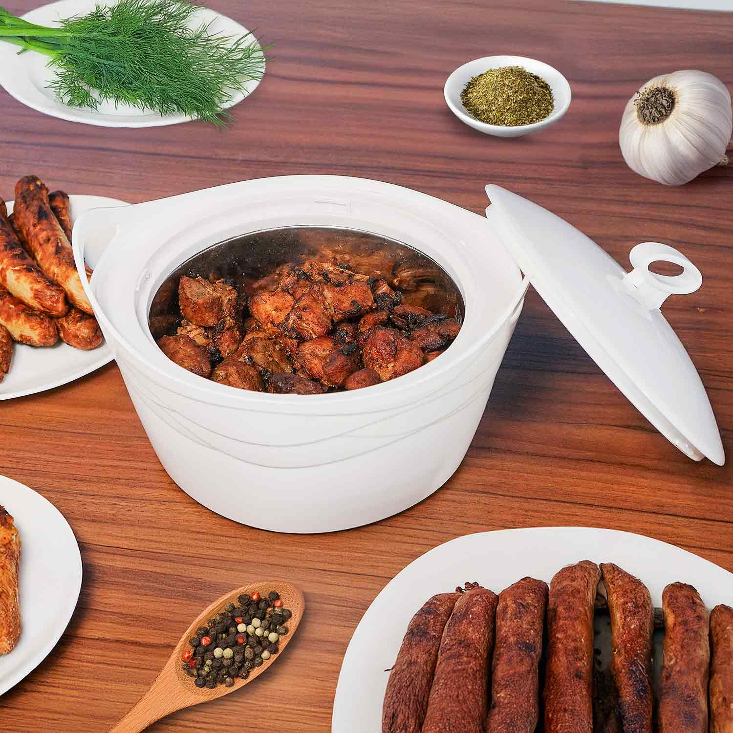 Ein weißer Kochtopf mit gekochtem Essen, umgeben von Tellern mit Speisen und Kräutern.