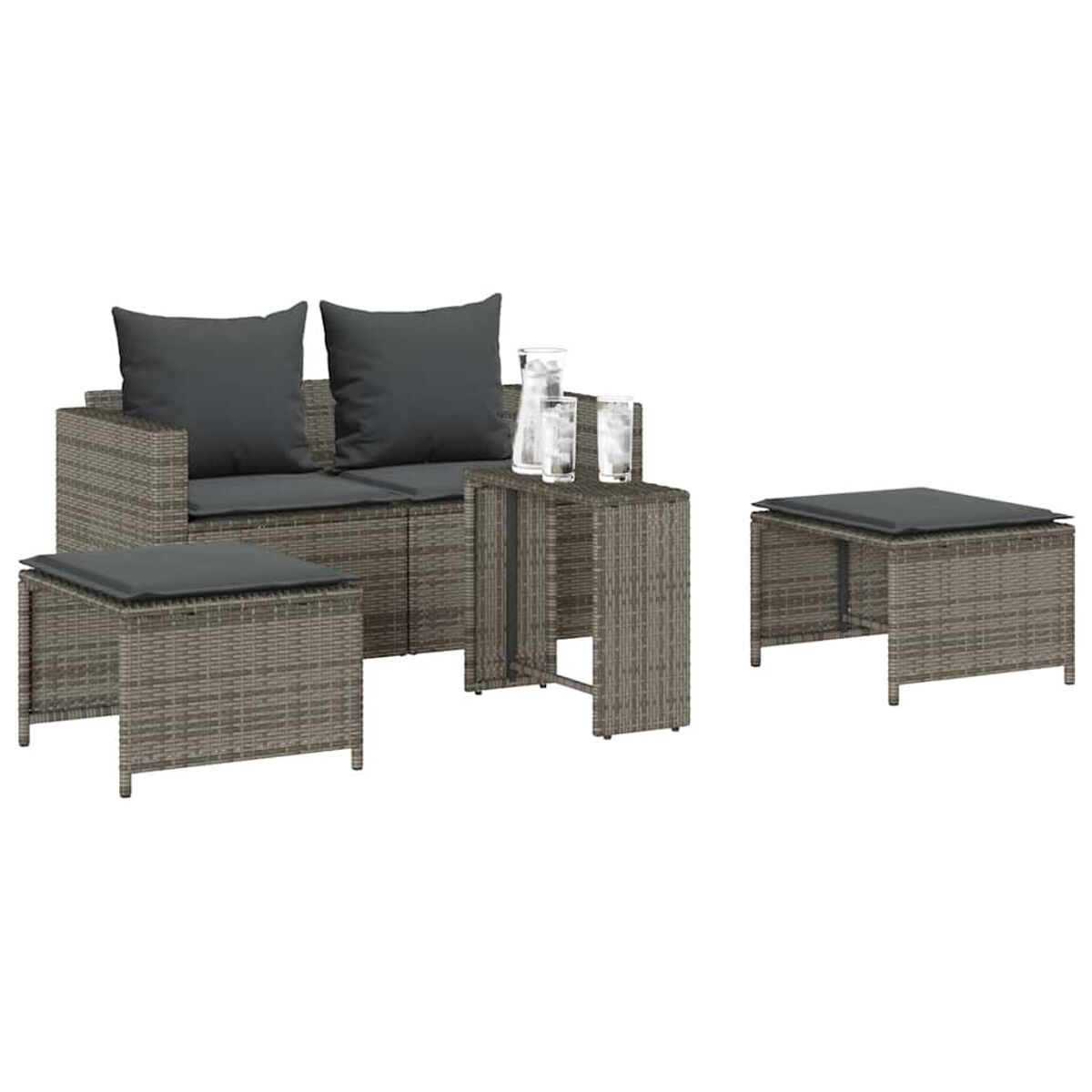 Set di mobili da esterno in vimini con tavolo e pouf.