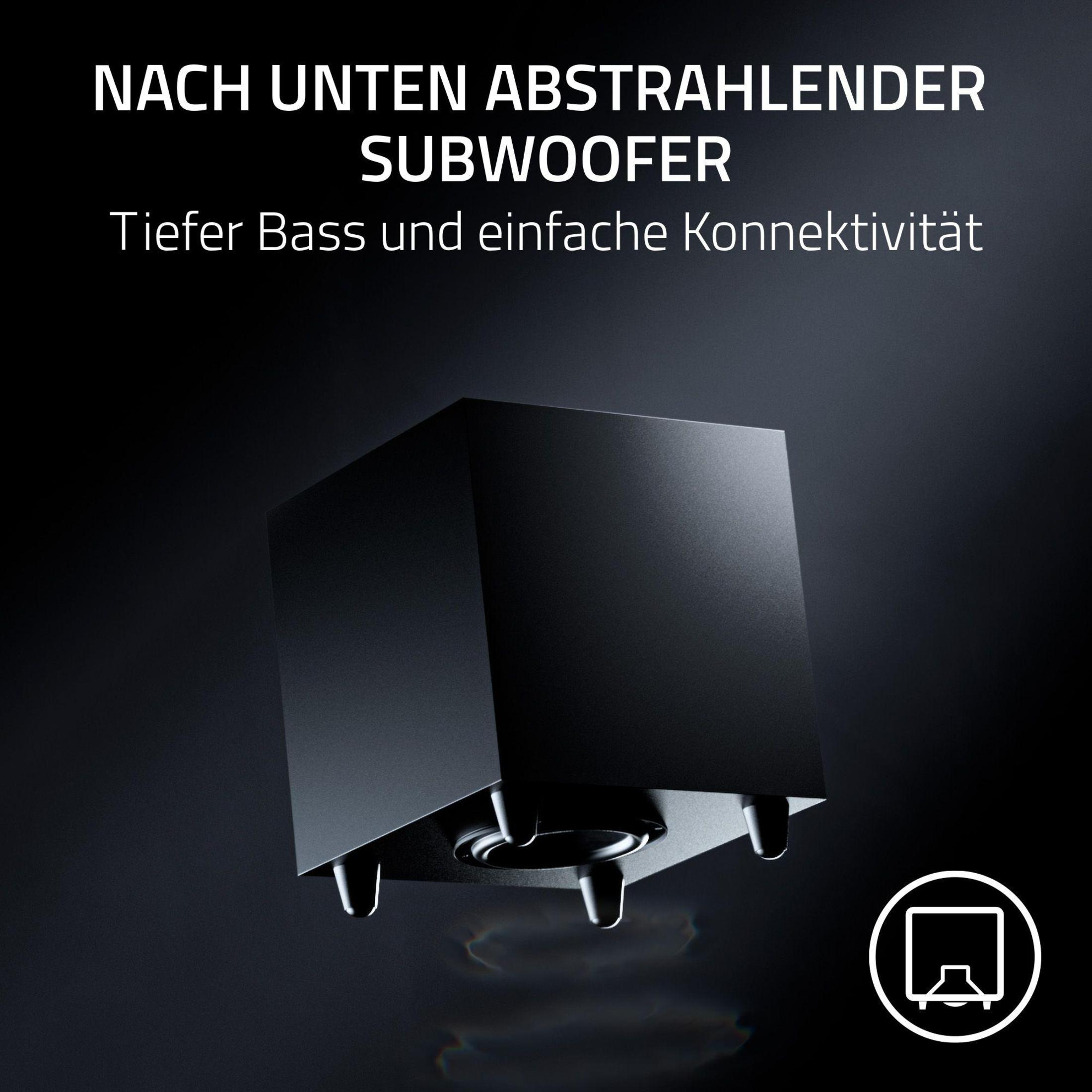 Czarny subwoofer z głośnikiem skierowanym w dół i trzema nóżkami, na ciemnym tle.