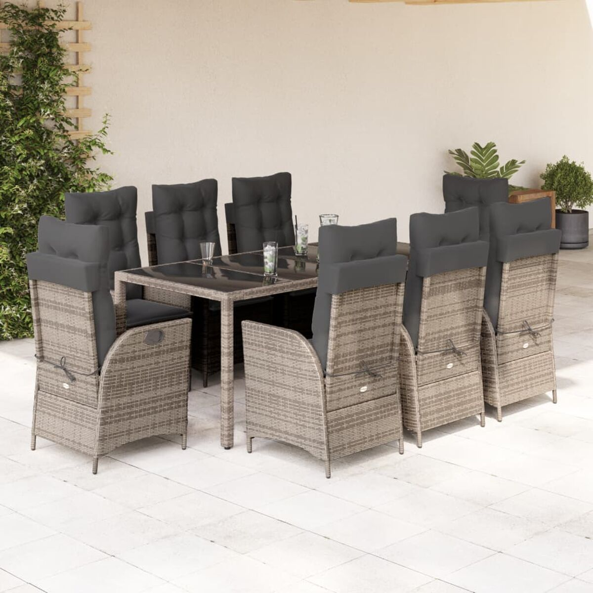 Set da pranzo per esterni con cuscini grigi. Tavolo e sedie su un patio.