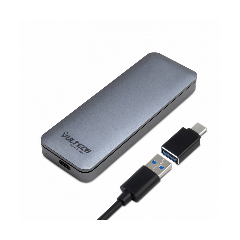 Un piccolo SSD esterno grigio e cavi per il trasferimento dati su sfondo bianco.