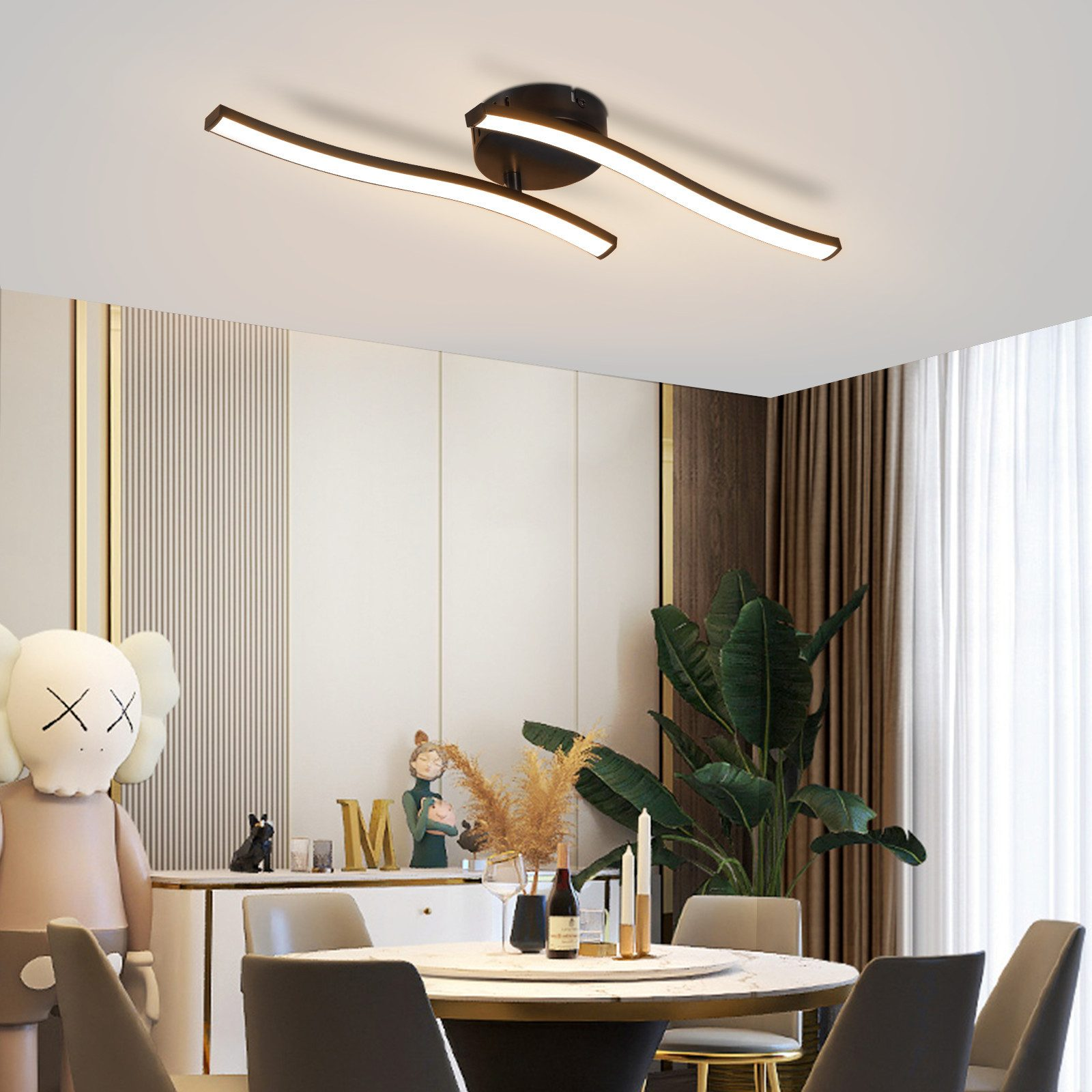 Soggiorno moderno con luci a soffitto. Un tavolo con decorazioni e una grande pianta.