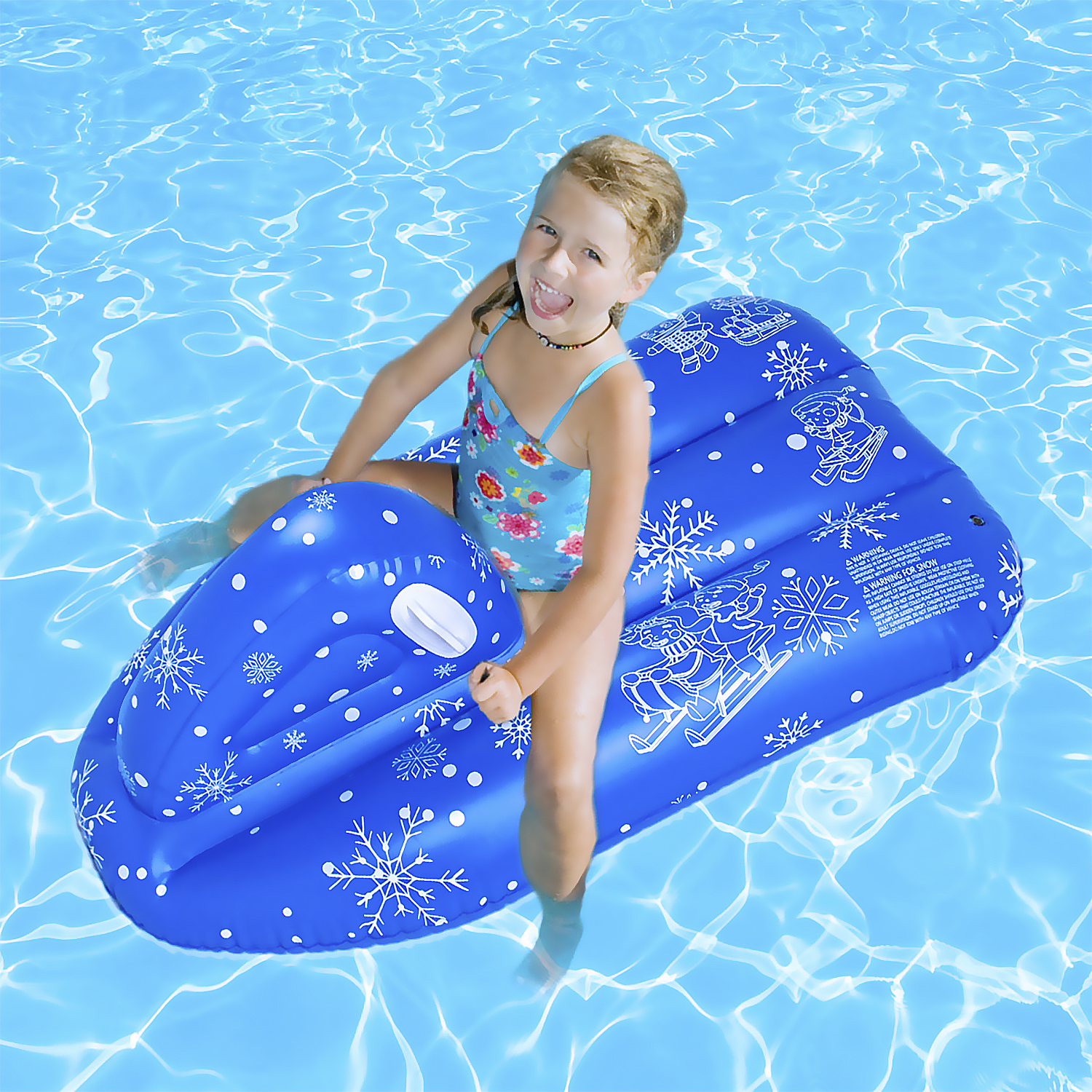 Una niña con traje de baño azul en una balsa inflable azul en una piscina. Sonriendo.