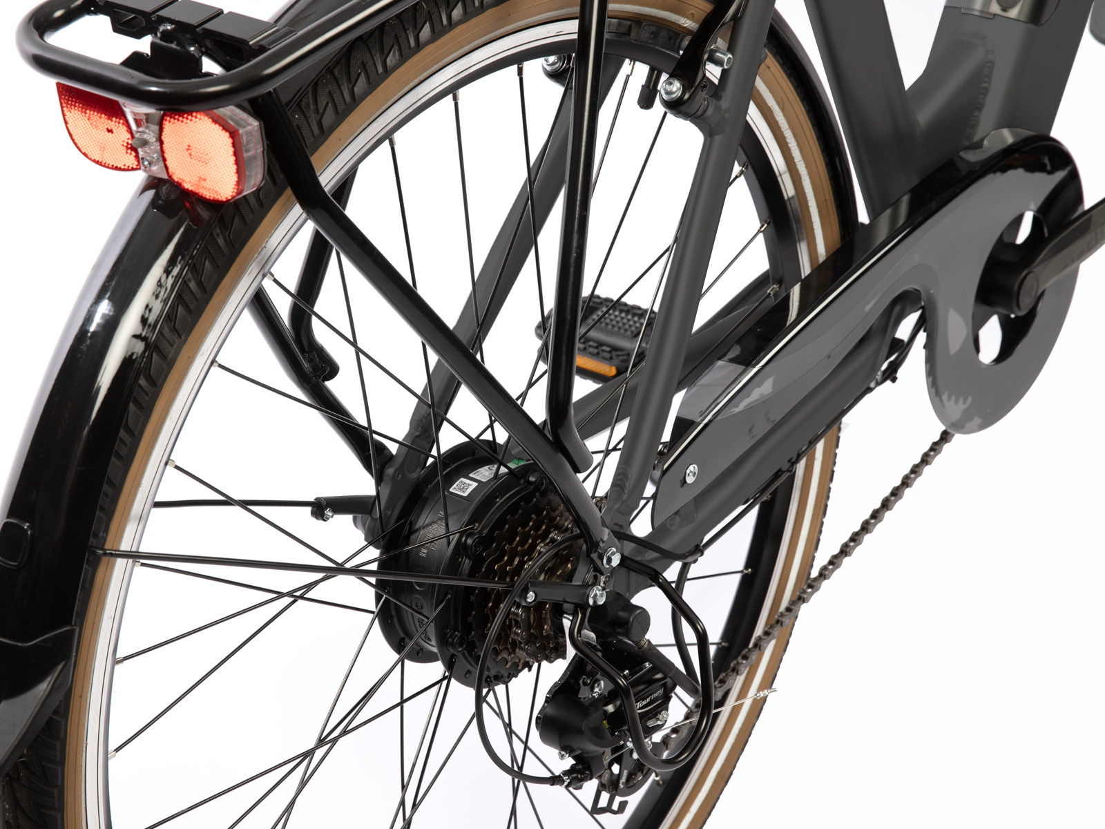 Close-up of a bicycle's rear wheel and components, including gears, chain, and brake light.