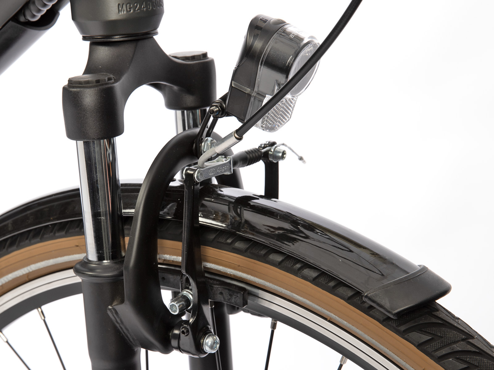 Close-up of the front wheel and brakes of a black bicycle. The tire is brown.