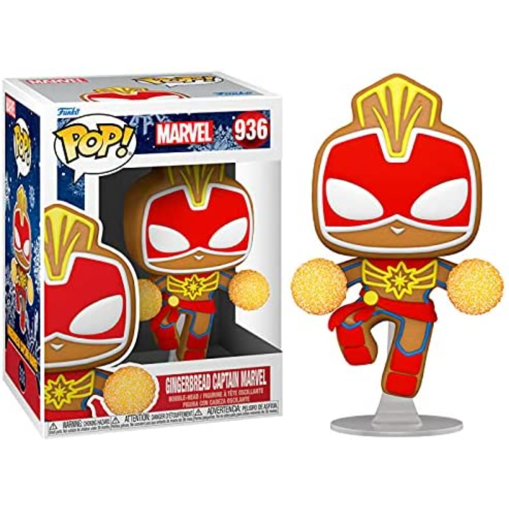 Figura di Captain Marvel in pan di zenzero in una scatola ed esposta. La figura è rossa, marrone e gialla, con due dettagli circolari.