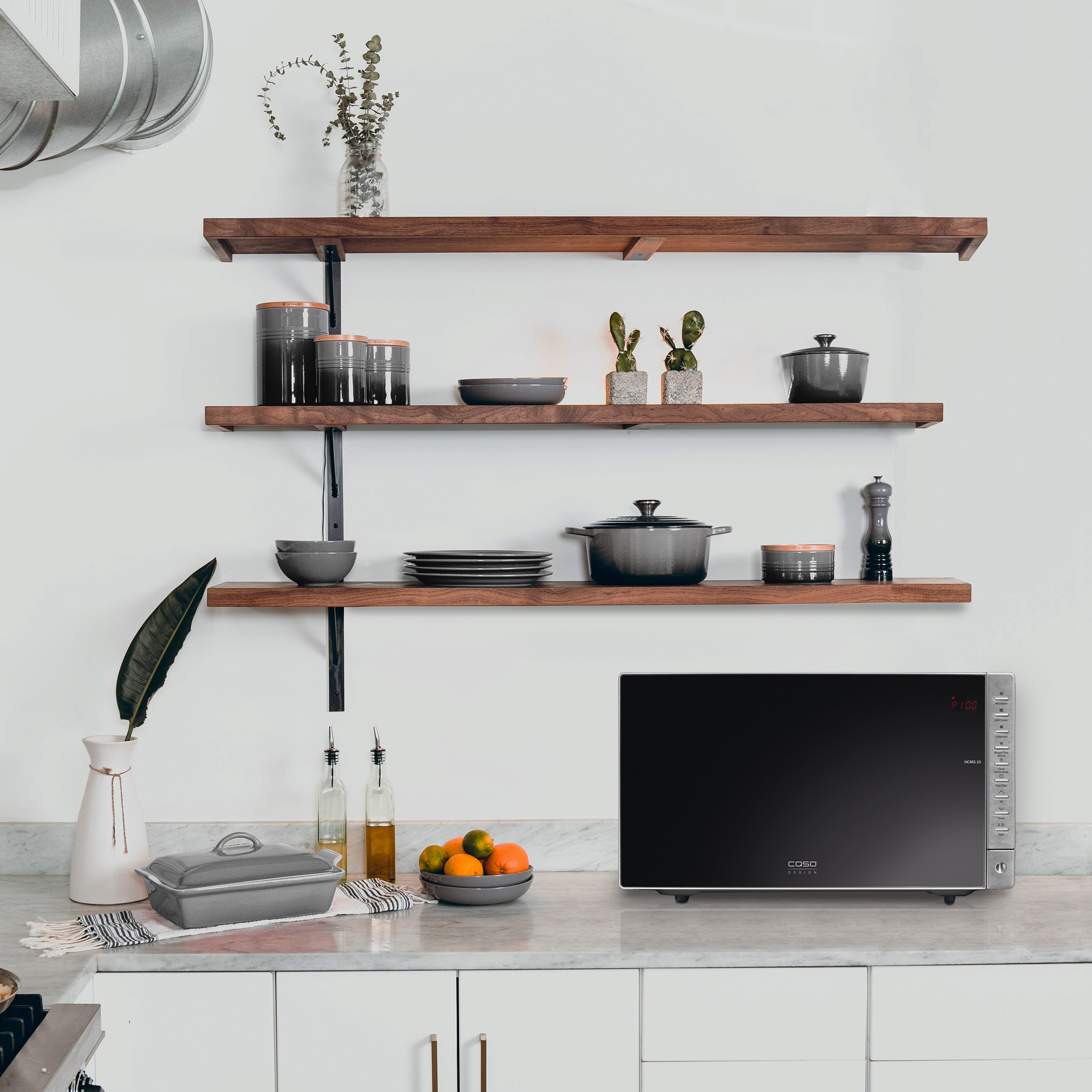 Comptoir de cuisine avec micro-ondes et autres articles. Armoires blanches.