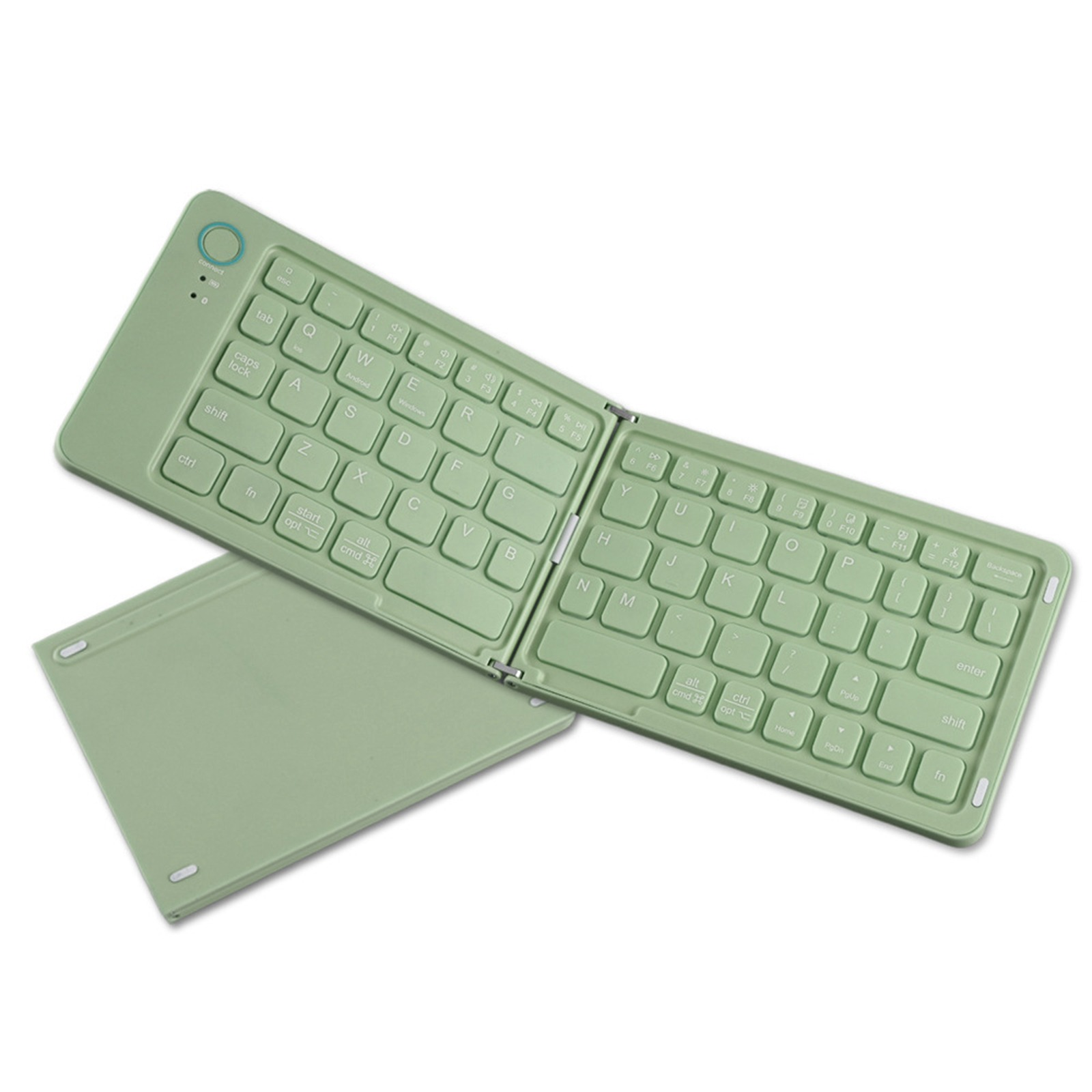 Faltbare grüne Tastatur ausgeklappt, mit separater grüner Abdeckung, auf weißer Oberfläche.