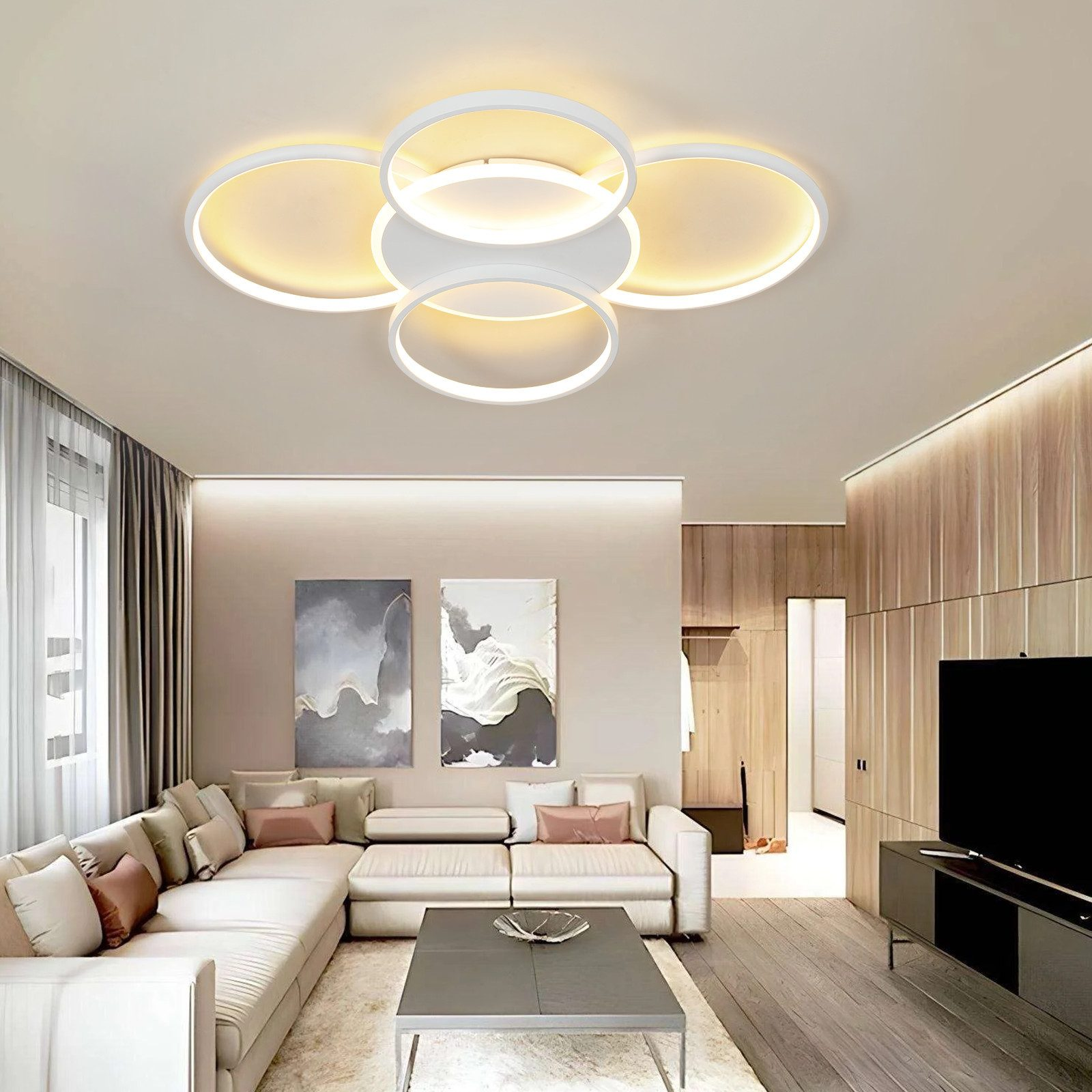 Un salón moderno con una gran lámpara de techo blanca, un sofá y obras de arte en la pared.