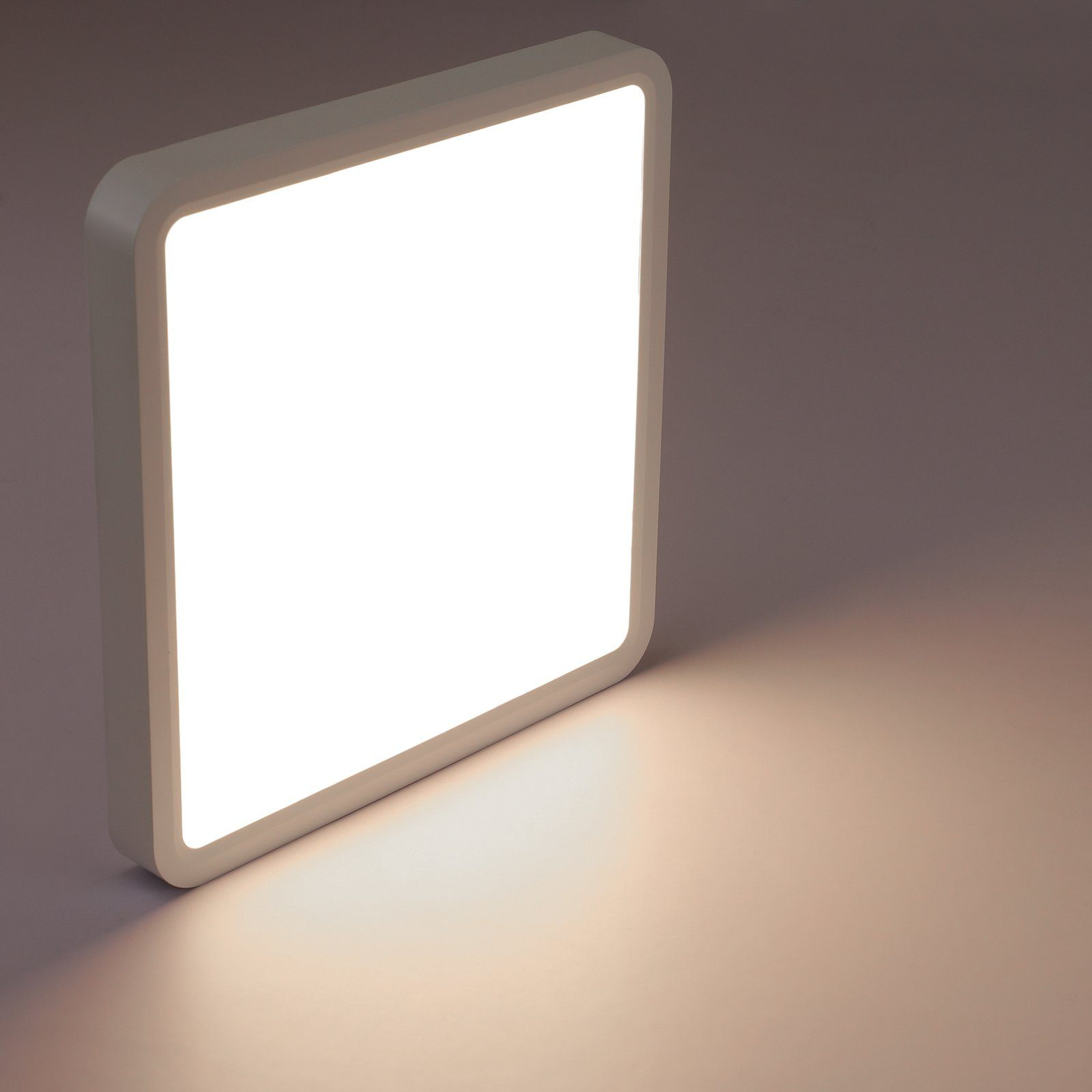 Kwadratowa, biała lampa sufitowa LED emitująca jasne światło.