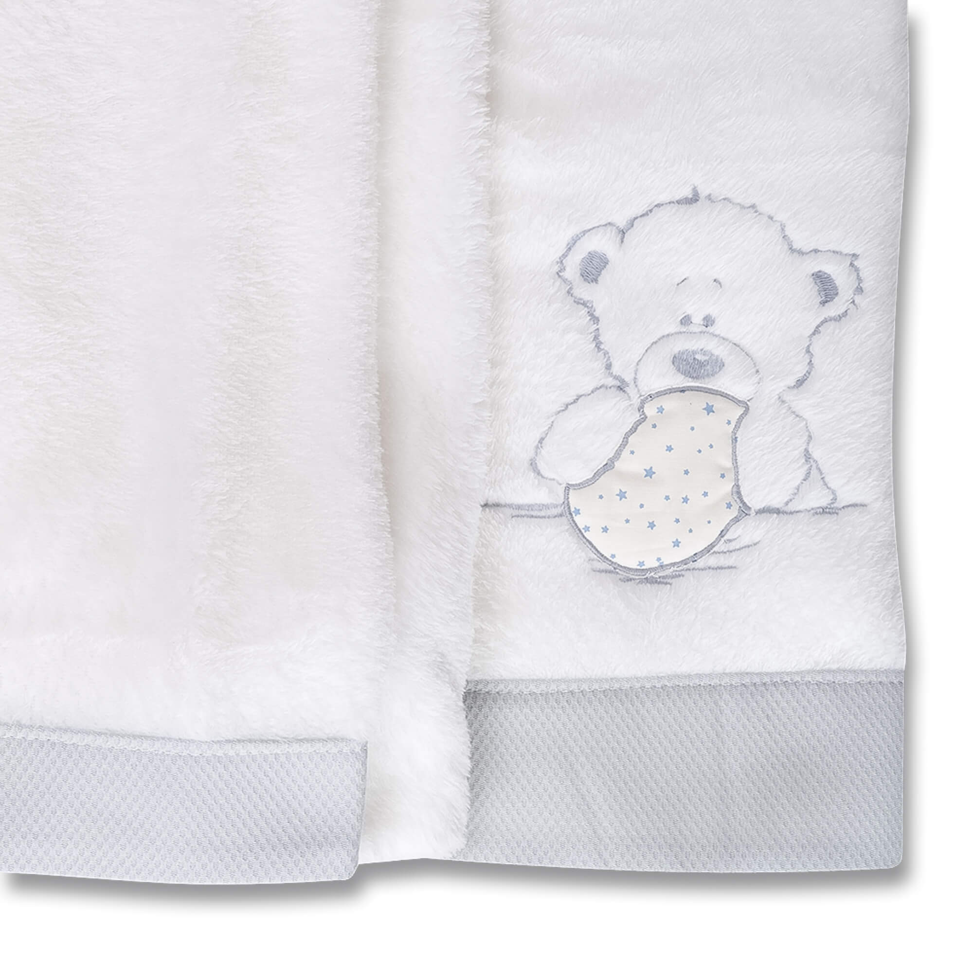 Manta blanca para bebé con diseño de osito de peluche. El oso sostiene una estrella.