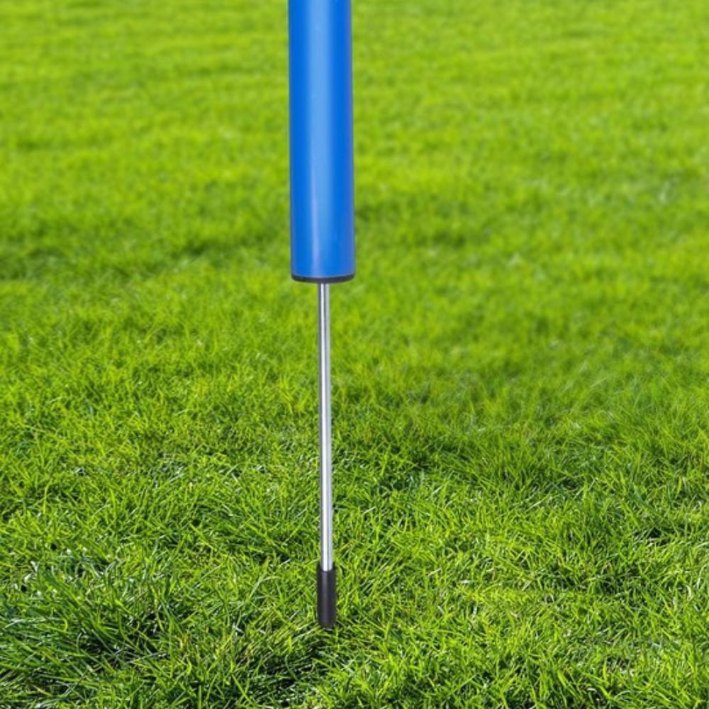 A blue pole base with a metal stem inserted into green grass.