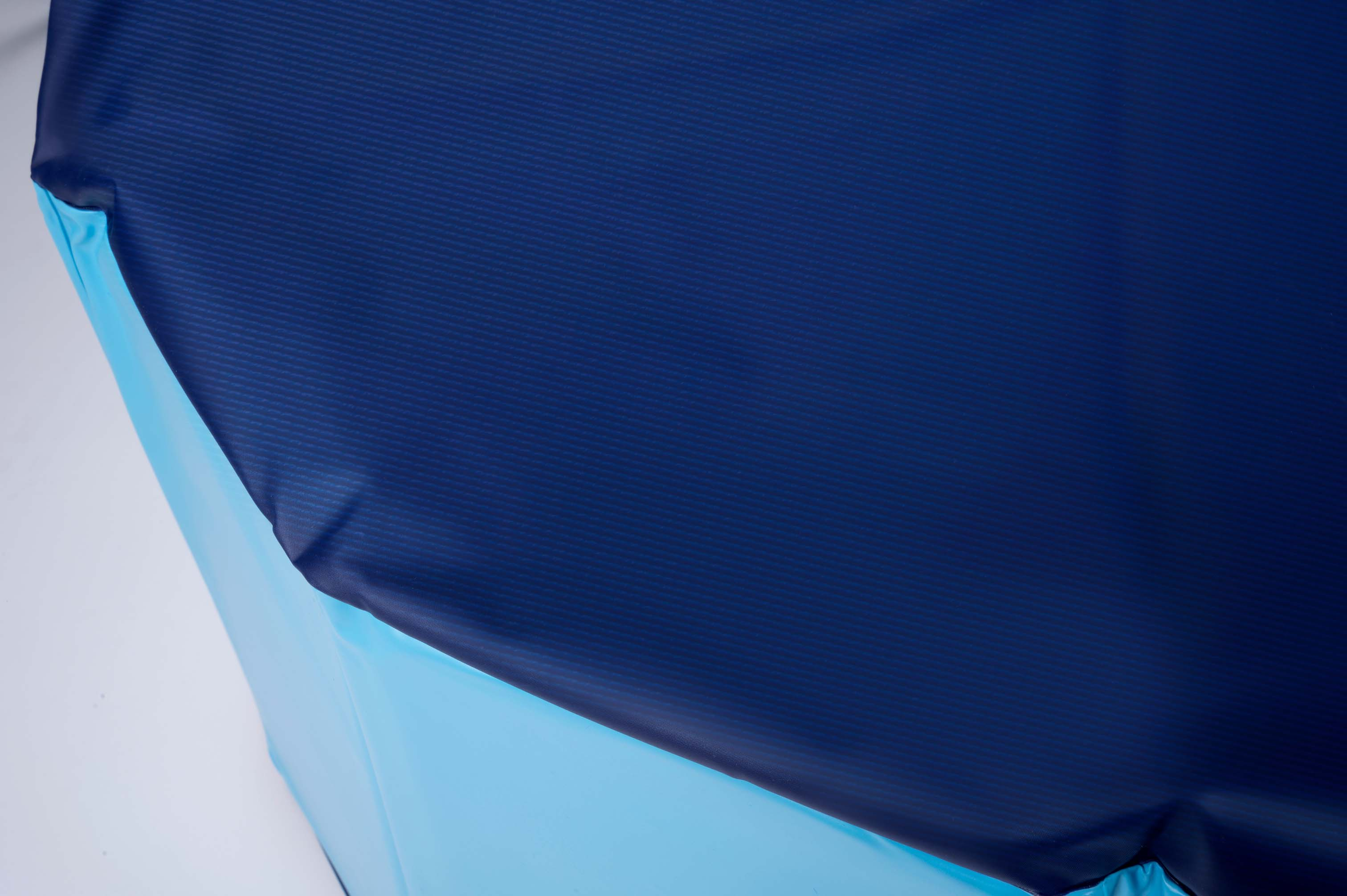A light blue and a dark blue fabric surface with fine lines.