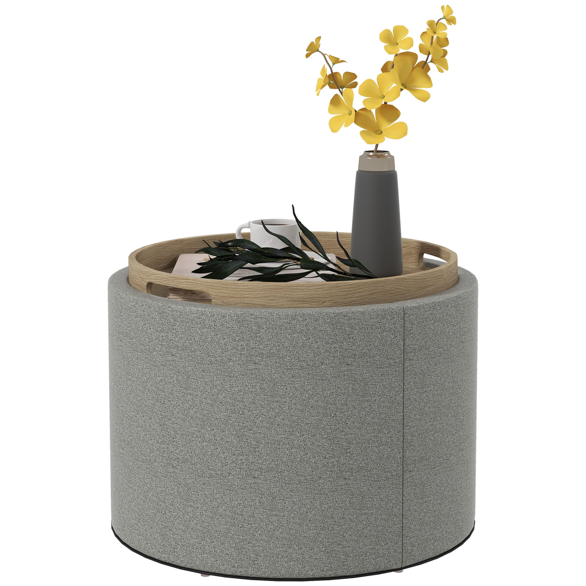 Pouf rotondo grigio con vassoio in legno, vaso con fiori gialli e una tazza di caffè.