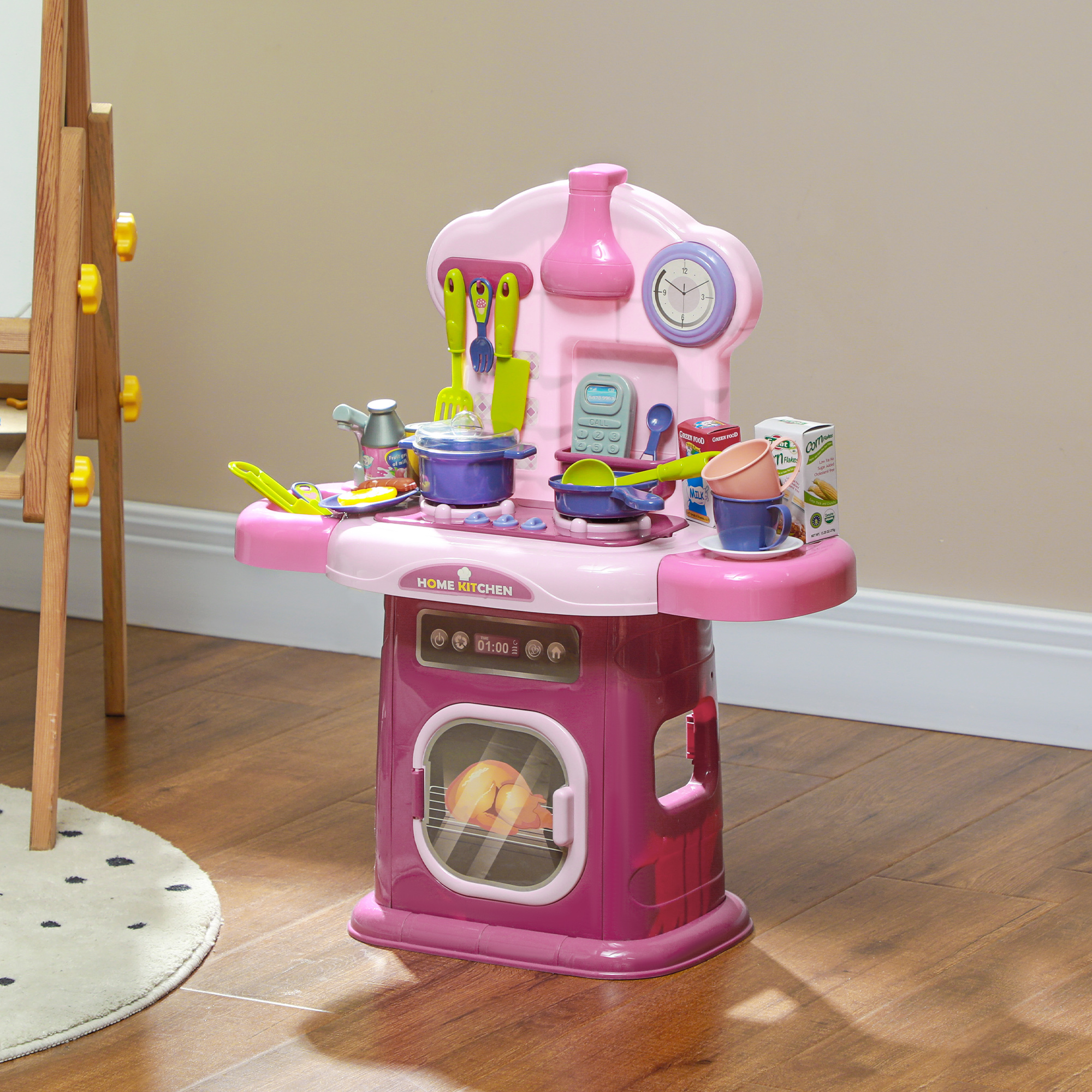 Cucina giocattolo rosa con accessori. Include un fornello, un forno e un orologio.