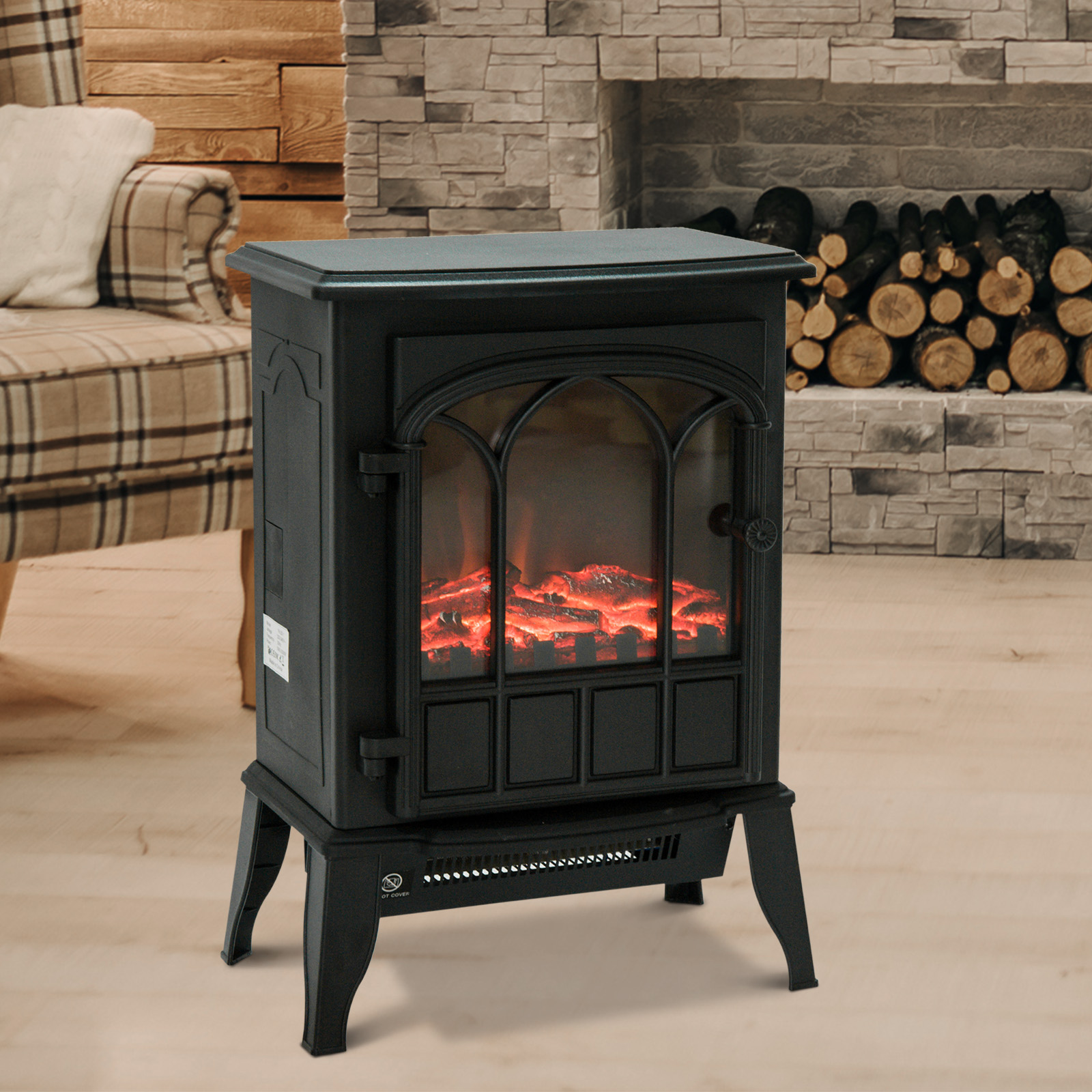Caminetto nero con fiamme, con frontale decorativo, su pavimento in legno.