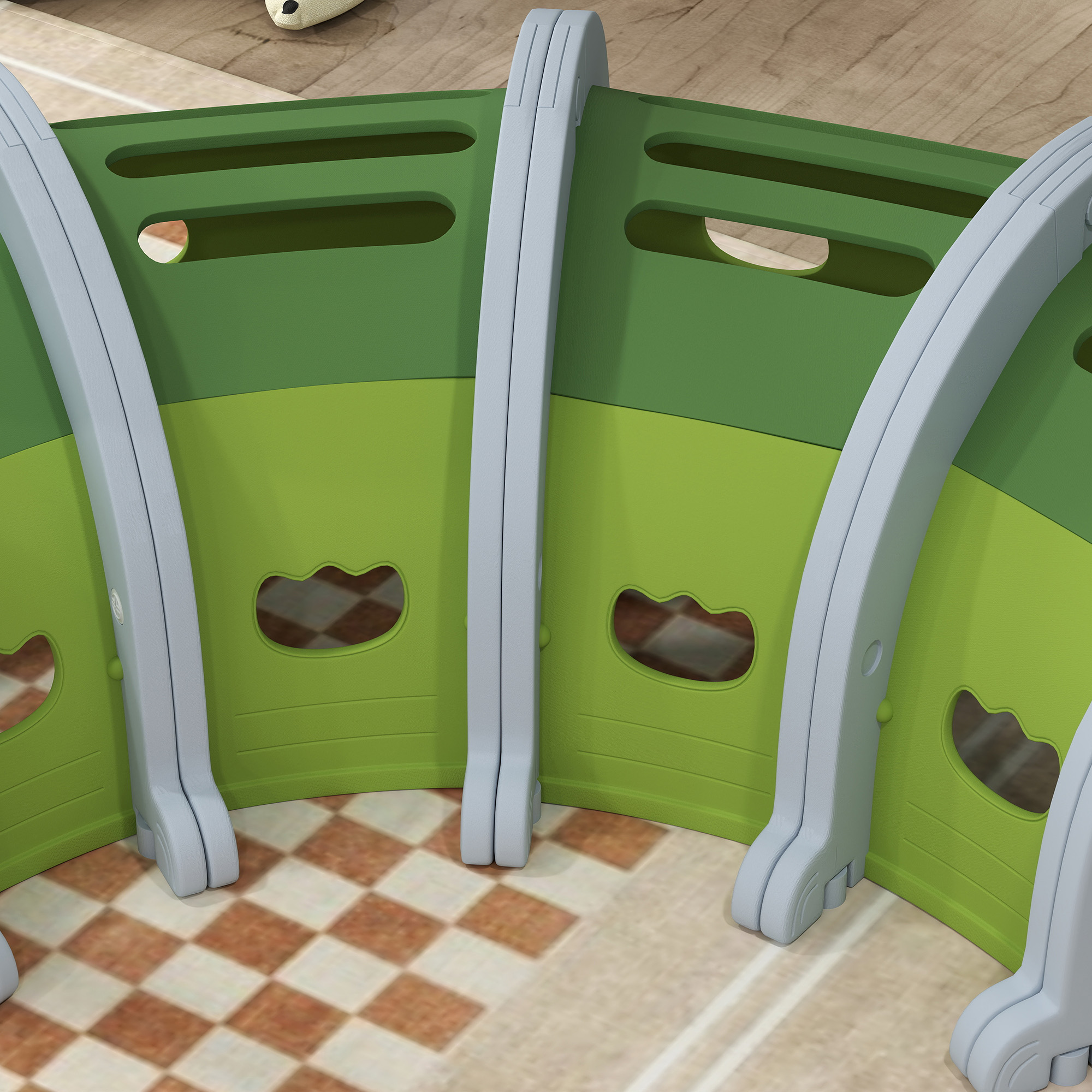 Un recinto per animali curvo in verde e grigio. Il recinto è su un pavimento a scacchi. Il design è modulare.