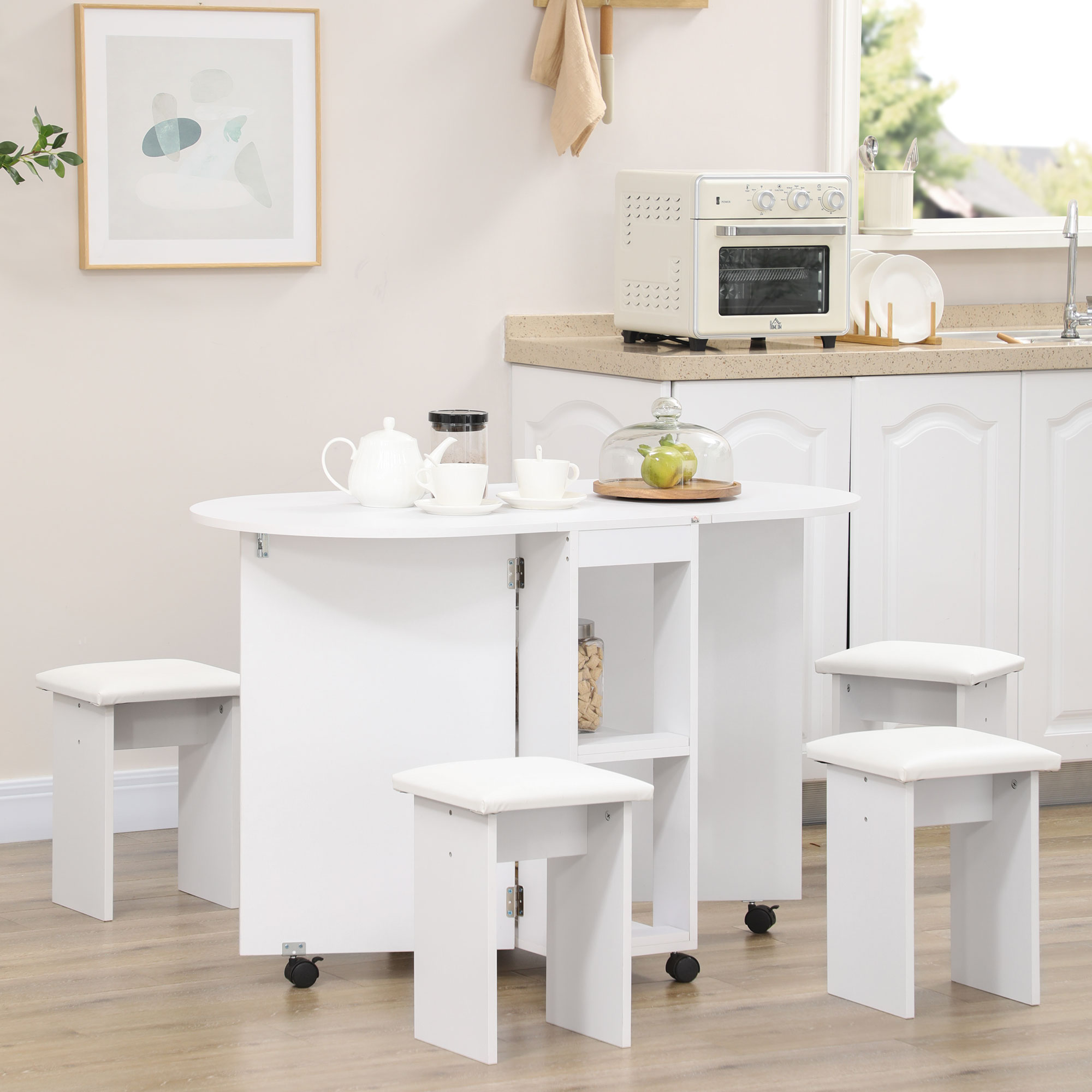 Tavolo da cucina pieghevole bianco con sgabelli e microonde sullo sfondo.