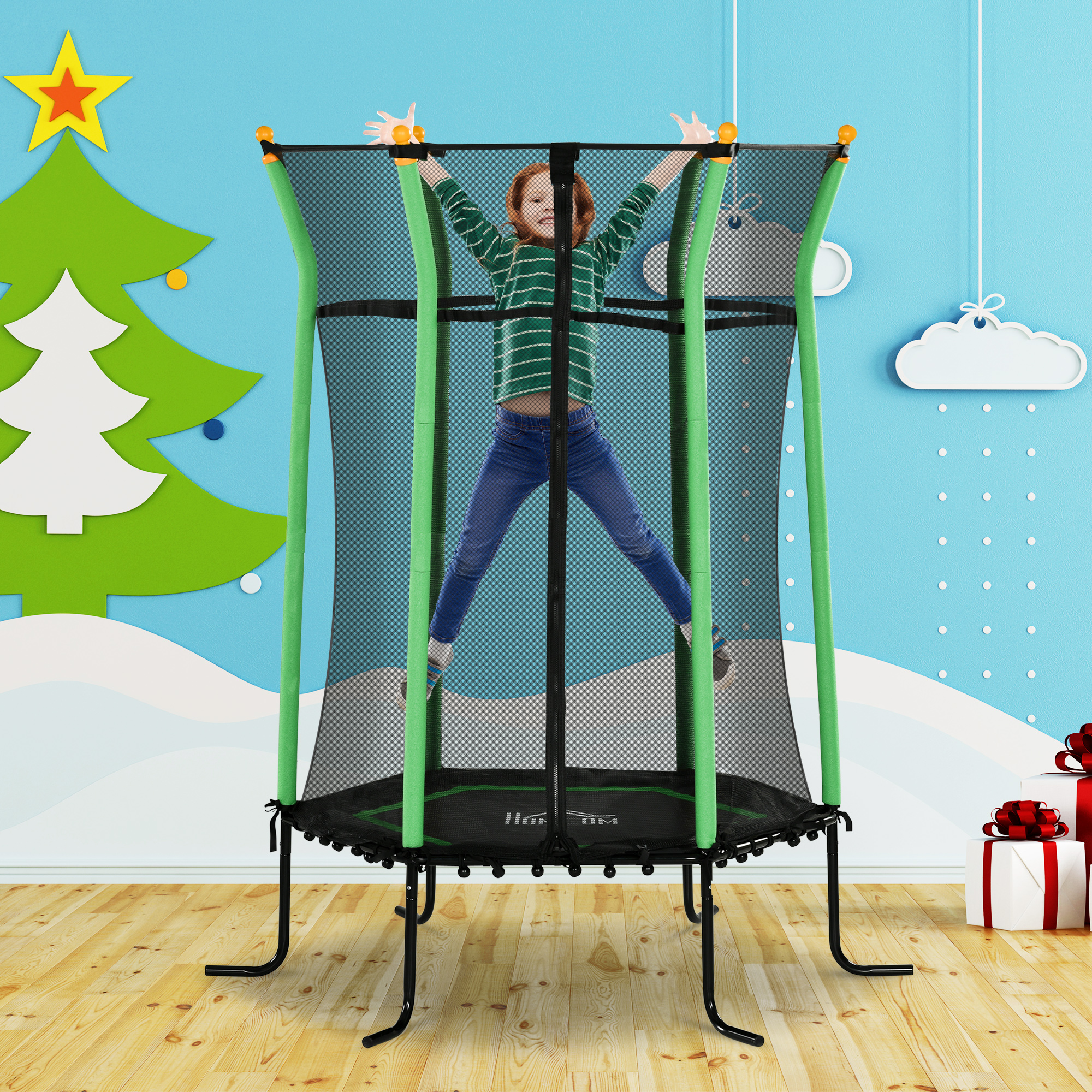 Un bambino salta su un trampolino in una stanza con una decorazione ad albero di Natale.