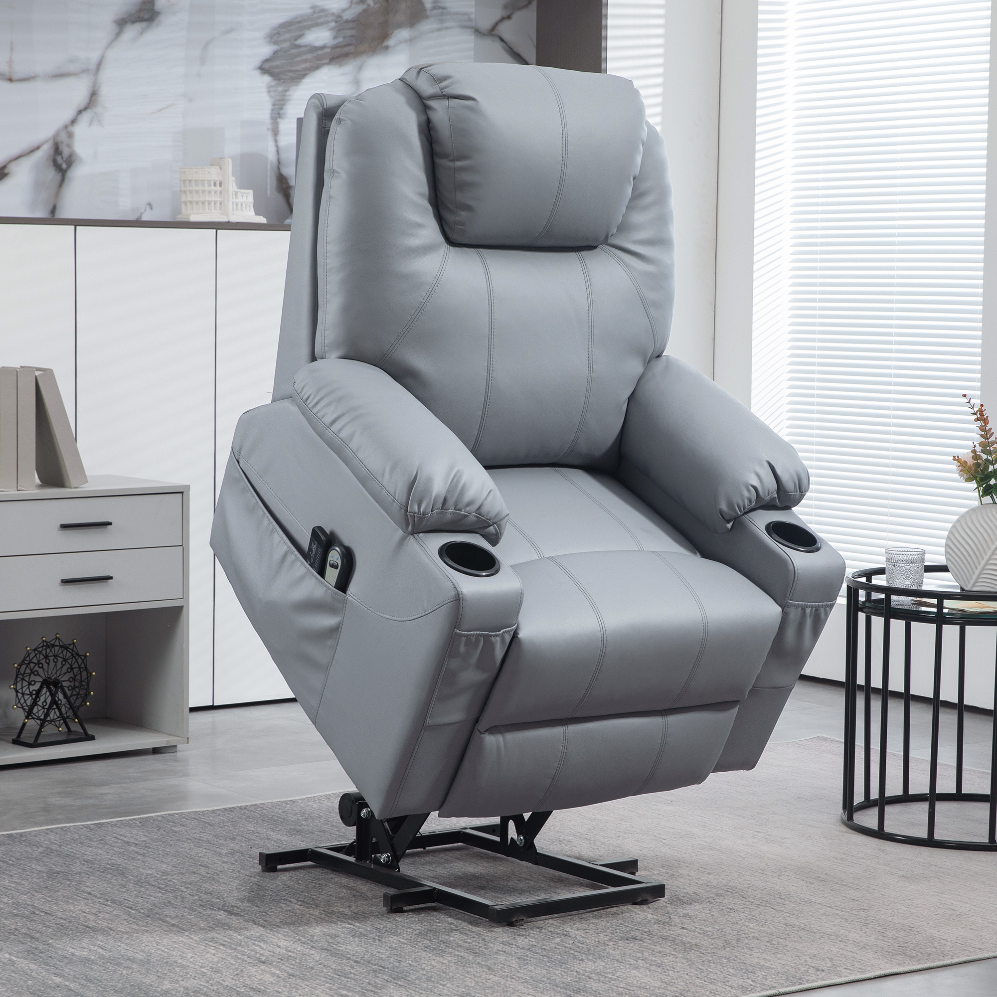 Poltrona reclinabile in pelle grigia con portabicchieri. Funzione lift. Interno.