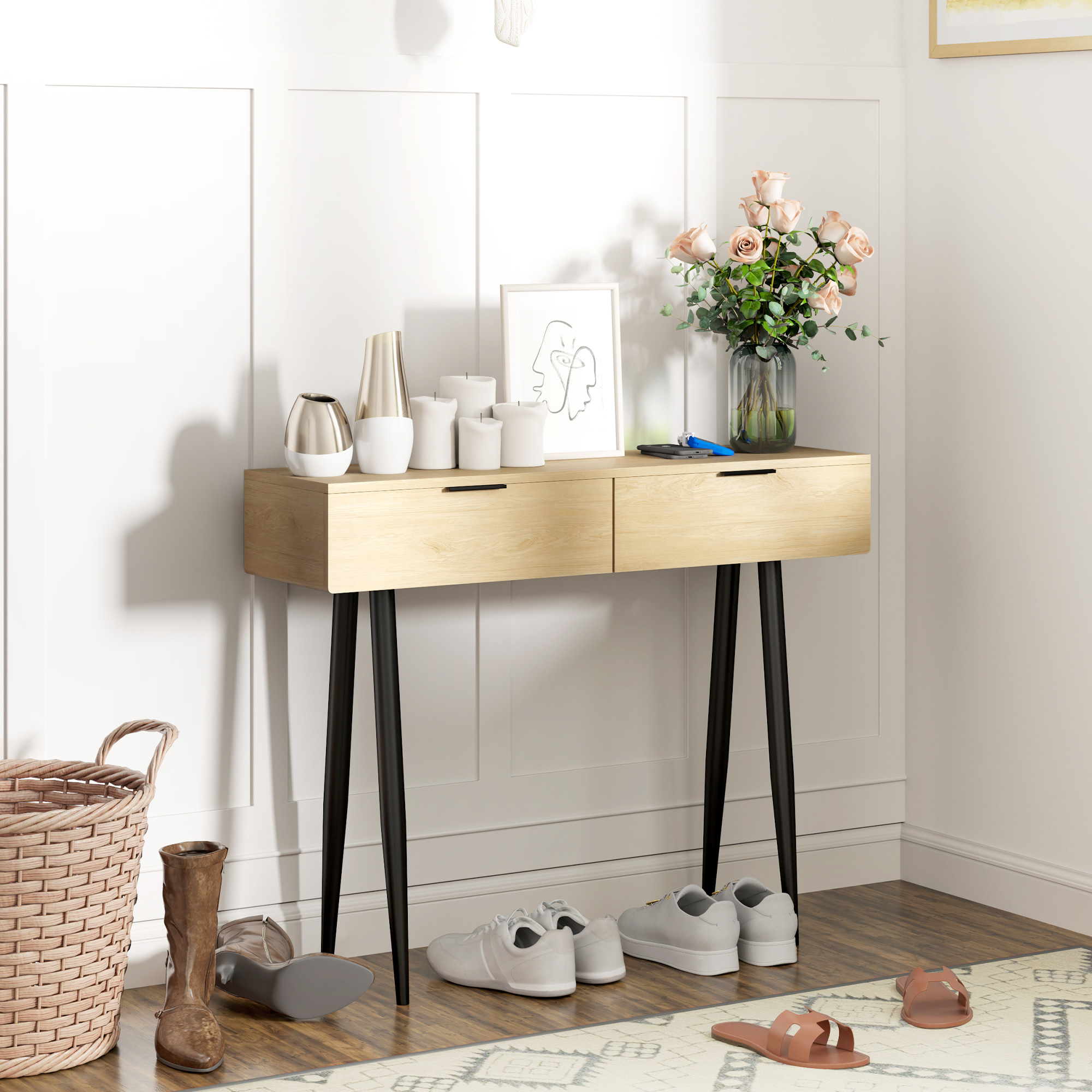 Mesa consola de madera con flores, velas y decoración contra pared blanca, patas negras.