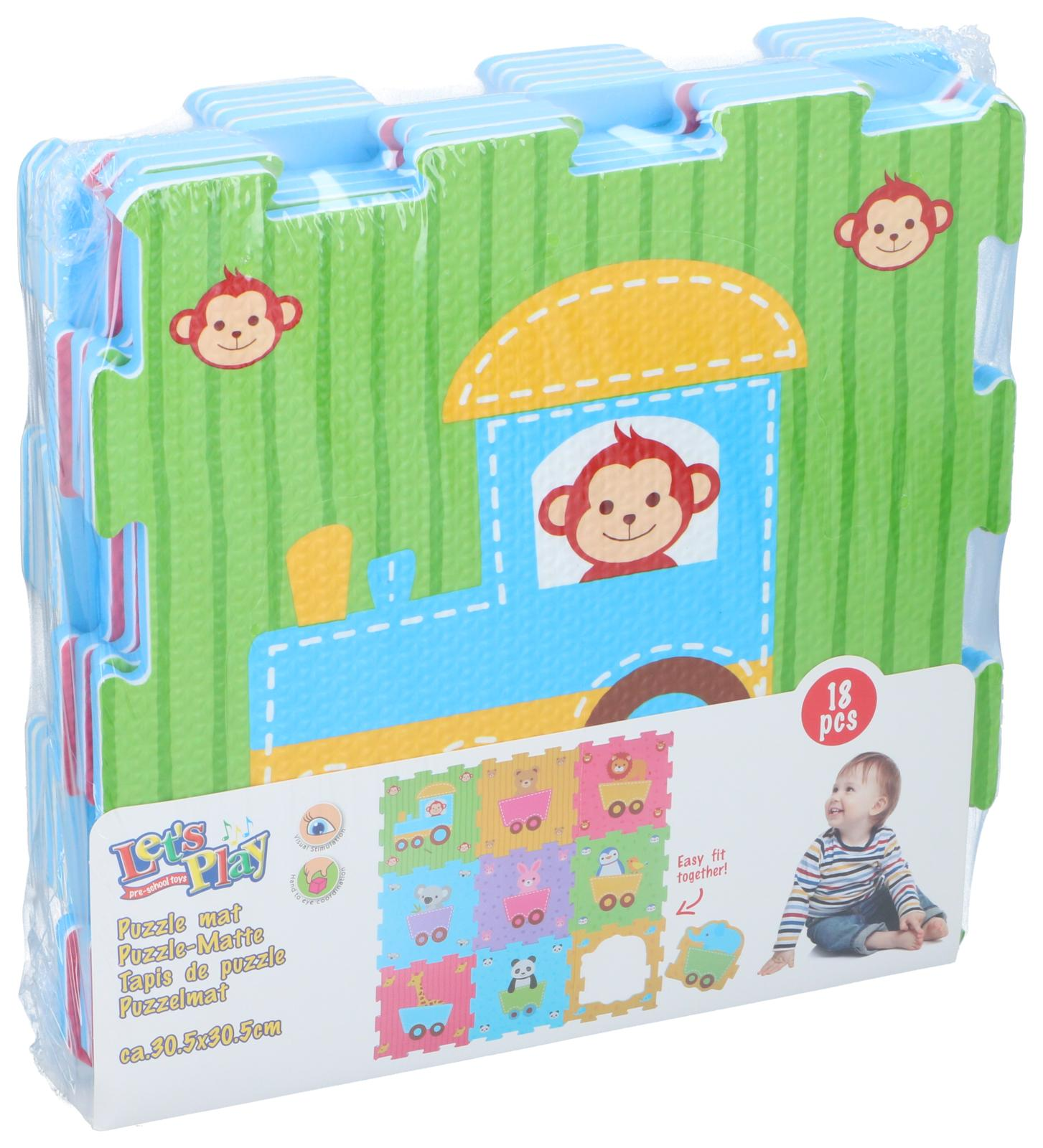 Puzzle mat set with a train design and monkey faces. A child sits near the packaging.