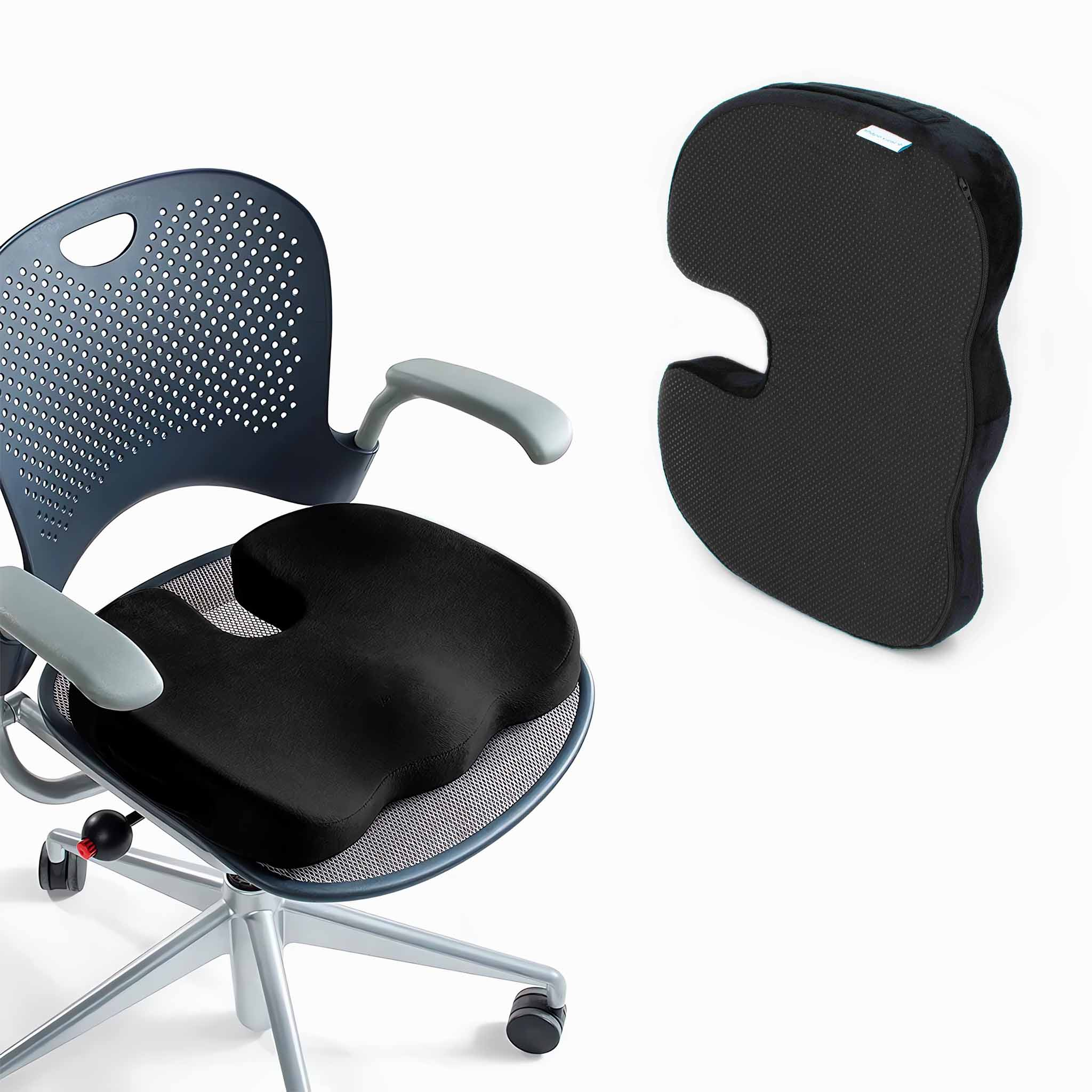 Schwarzes ergonomisches Sitzkissen auf einem Stuhl mit zweitem Kissen, beide vor weißem Grund.