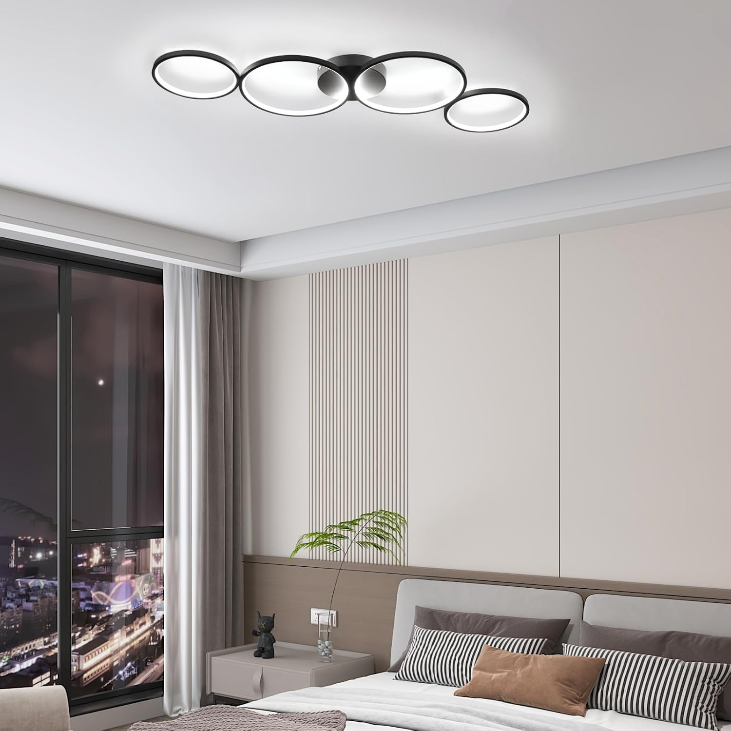 Un dormitorio moderno con una lámpara de techo negra con cuatro luces circulares.