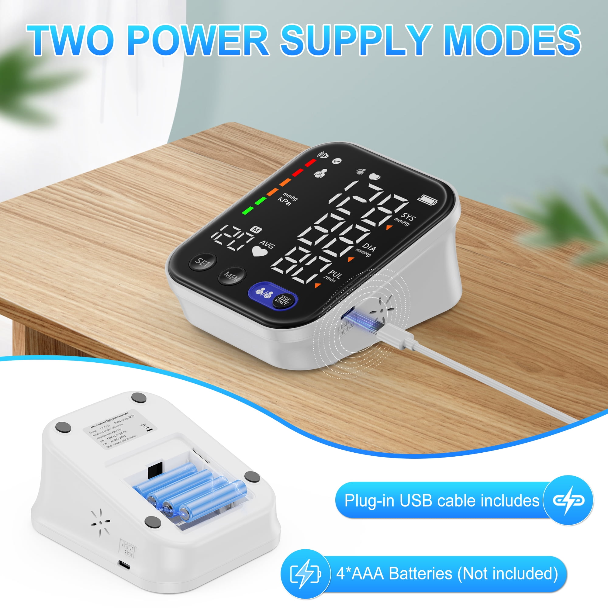 Ein Blutdruckmessgerät mit Digitalanzeige, Batterien und USB-Kabel zur Stromversorgung.