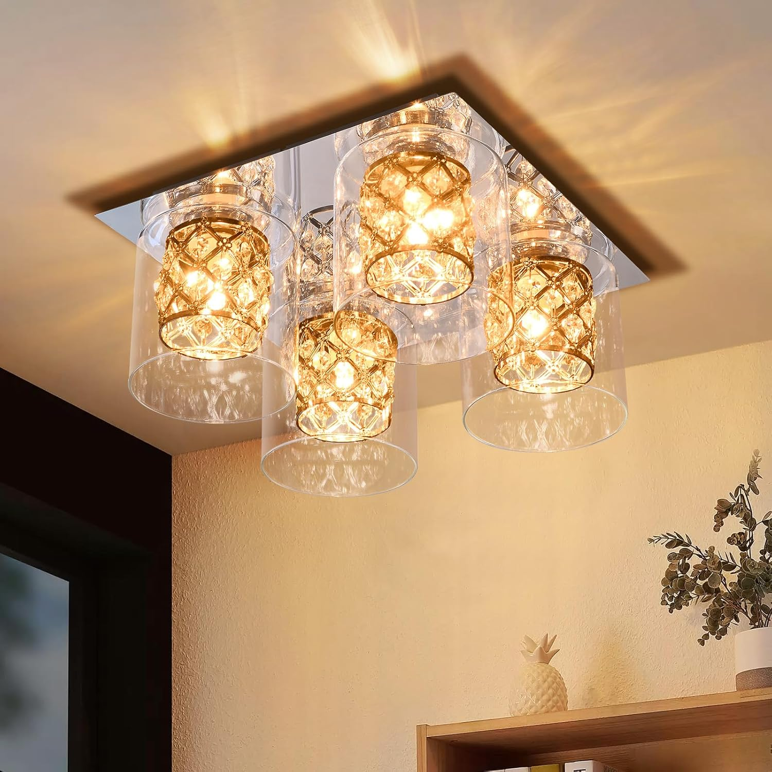 Lámpara de techo con múltiples luces con cristales. Las luces están encendidas.