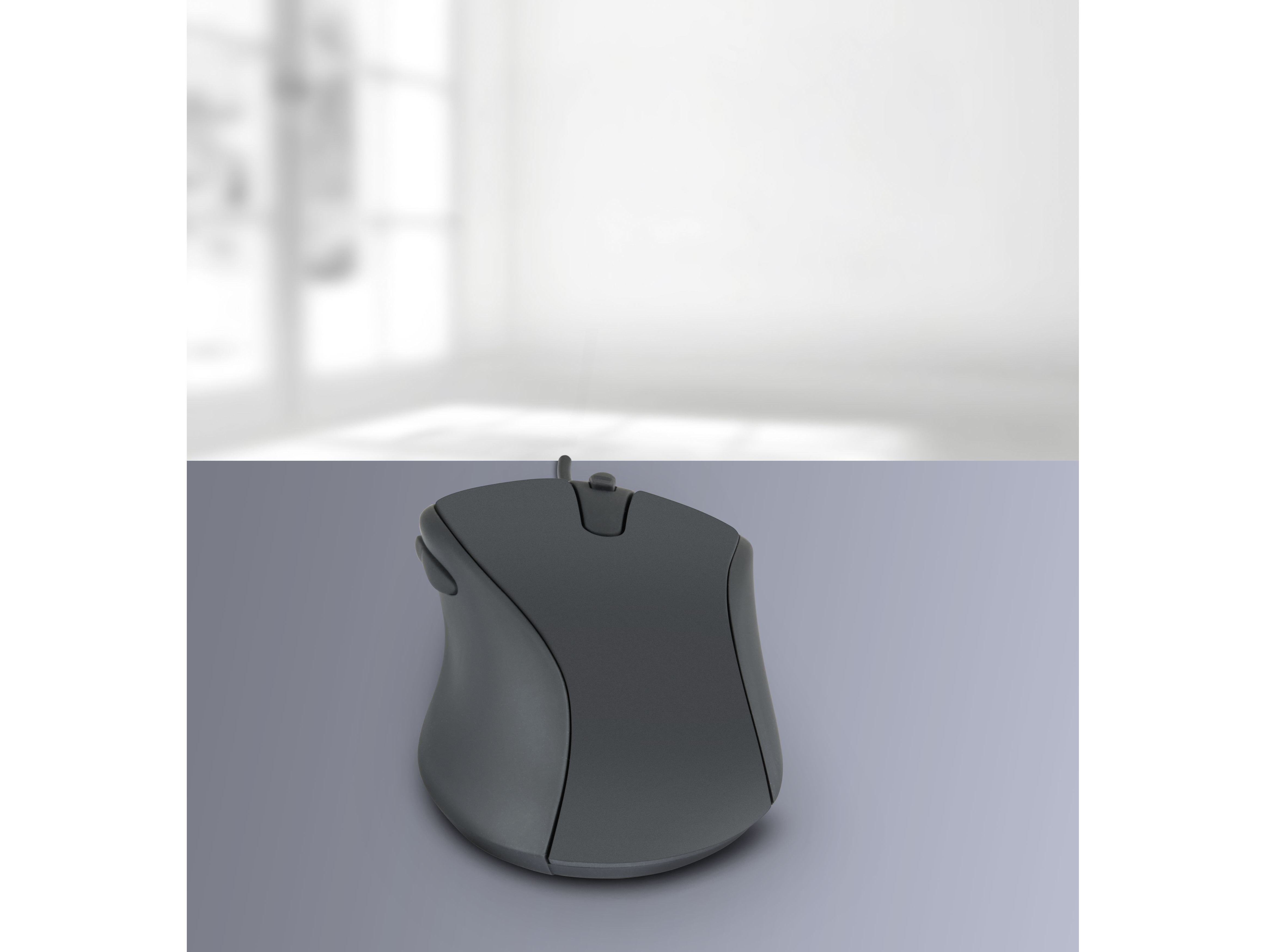 A grey computer mouse on a grey surface.