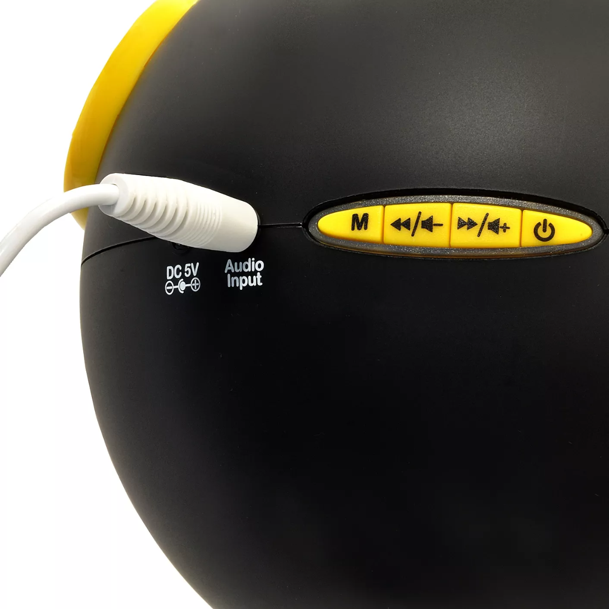 Primo piano di un altoparlante nero con pulsanti gialli e un cavo audio bianco collegato.